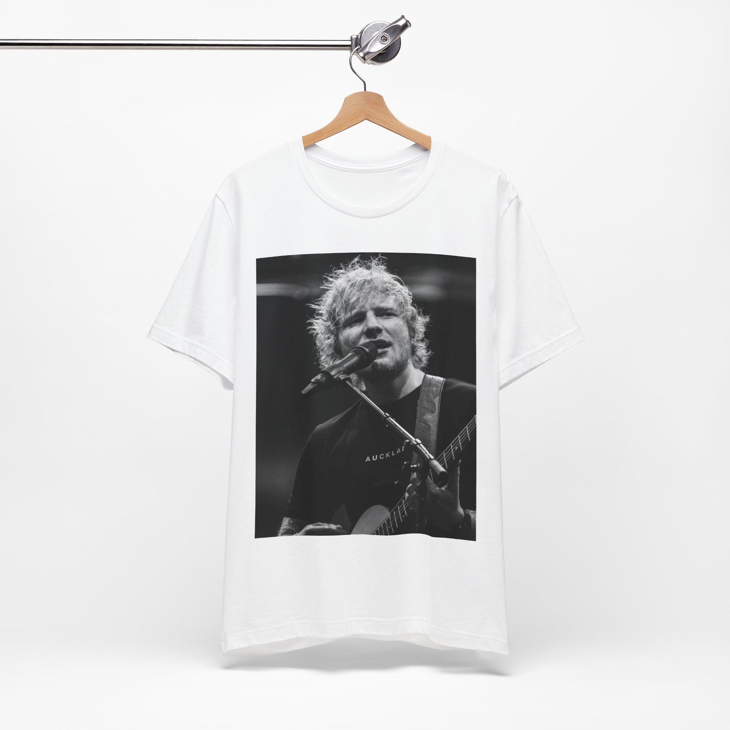 A black graphic t-shirt featuring a black and white photo of Ed Sheeran performing live.