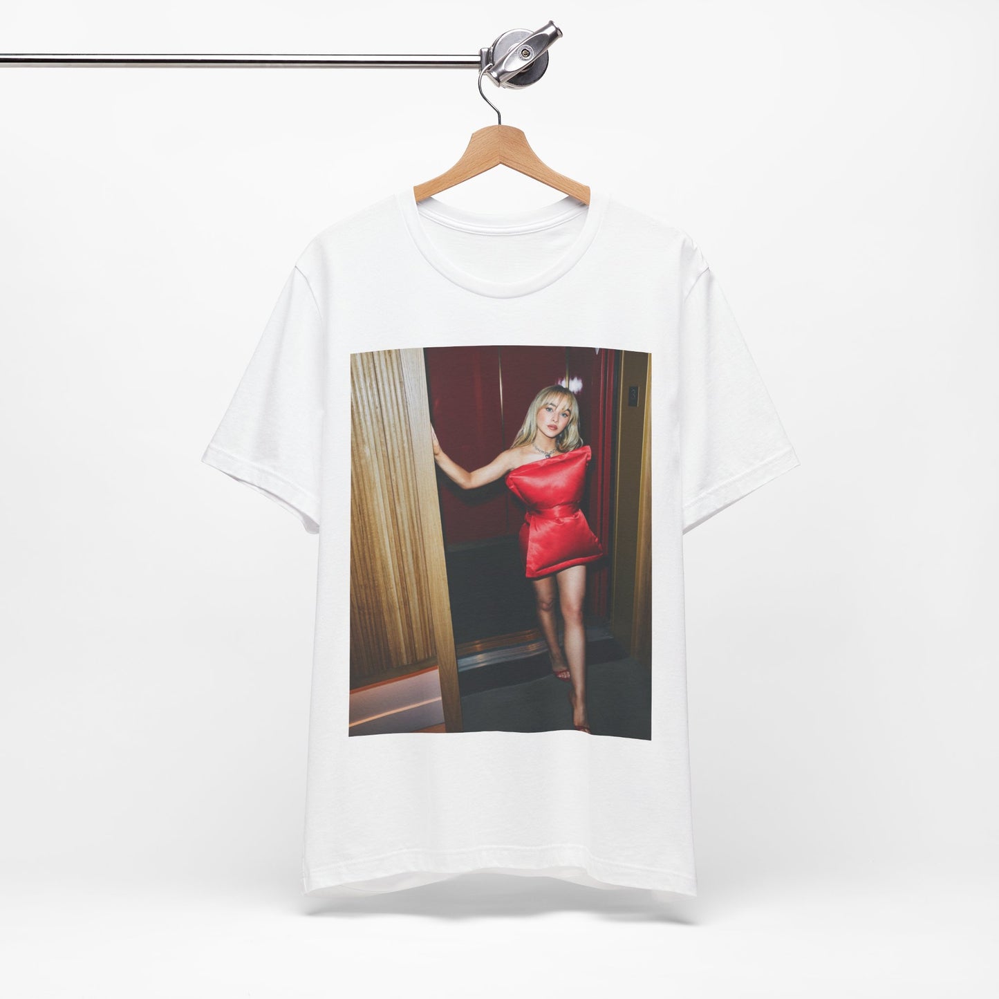 A black graphic t-shirt featuring a graphic of Sabrina Carpenter with 'hot pop vibes'.