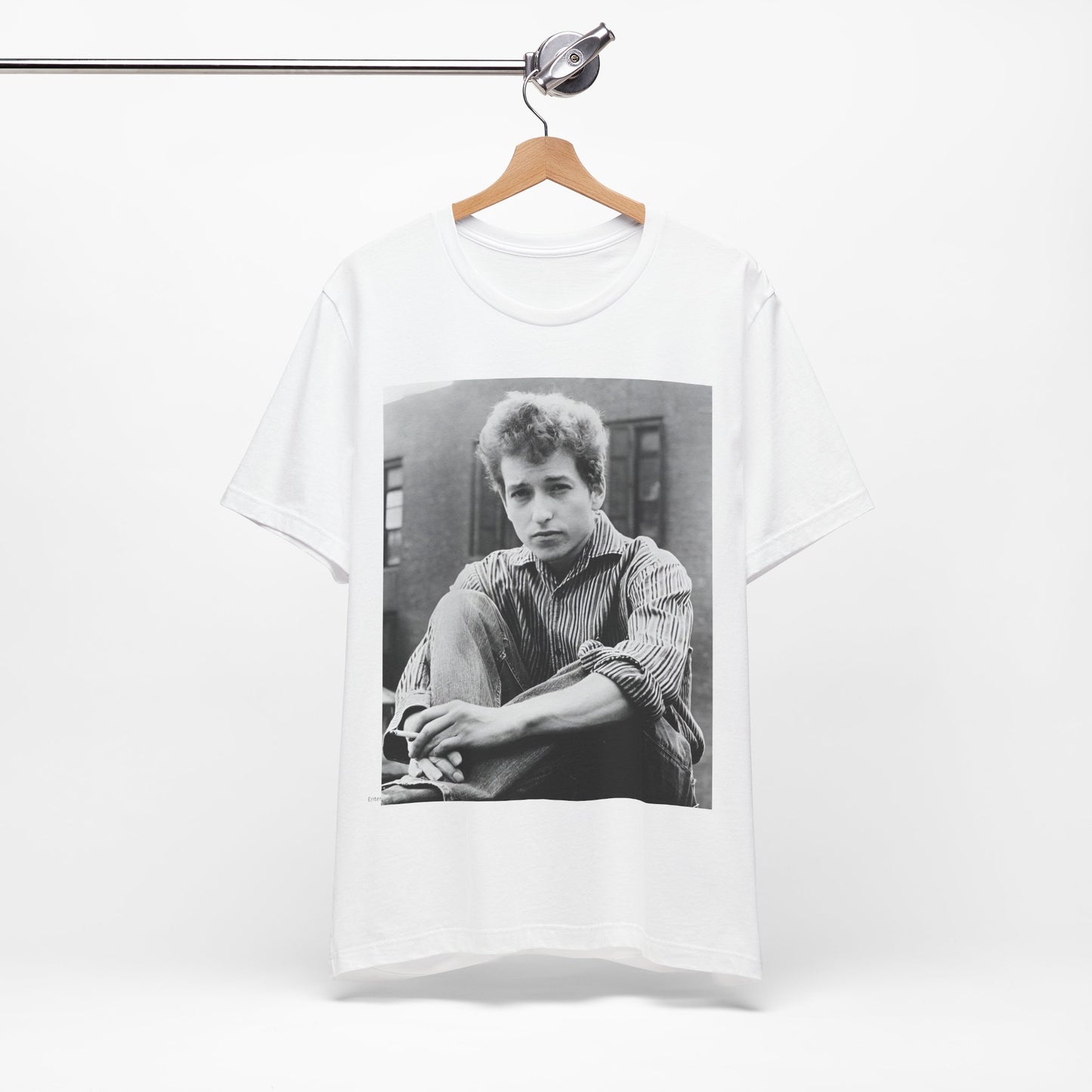 A black graphic t-shirt featuring a graphic of Bob Dylan from his 60s origins in folk music.