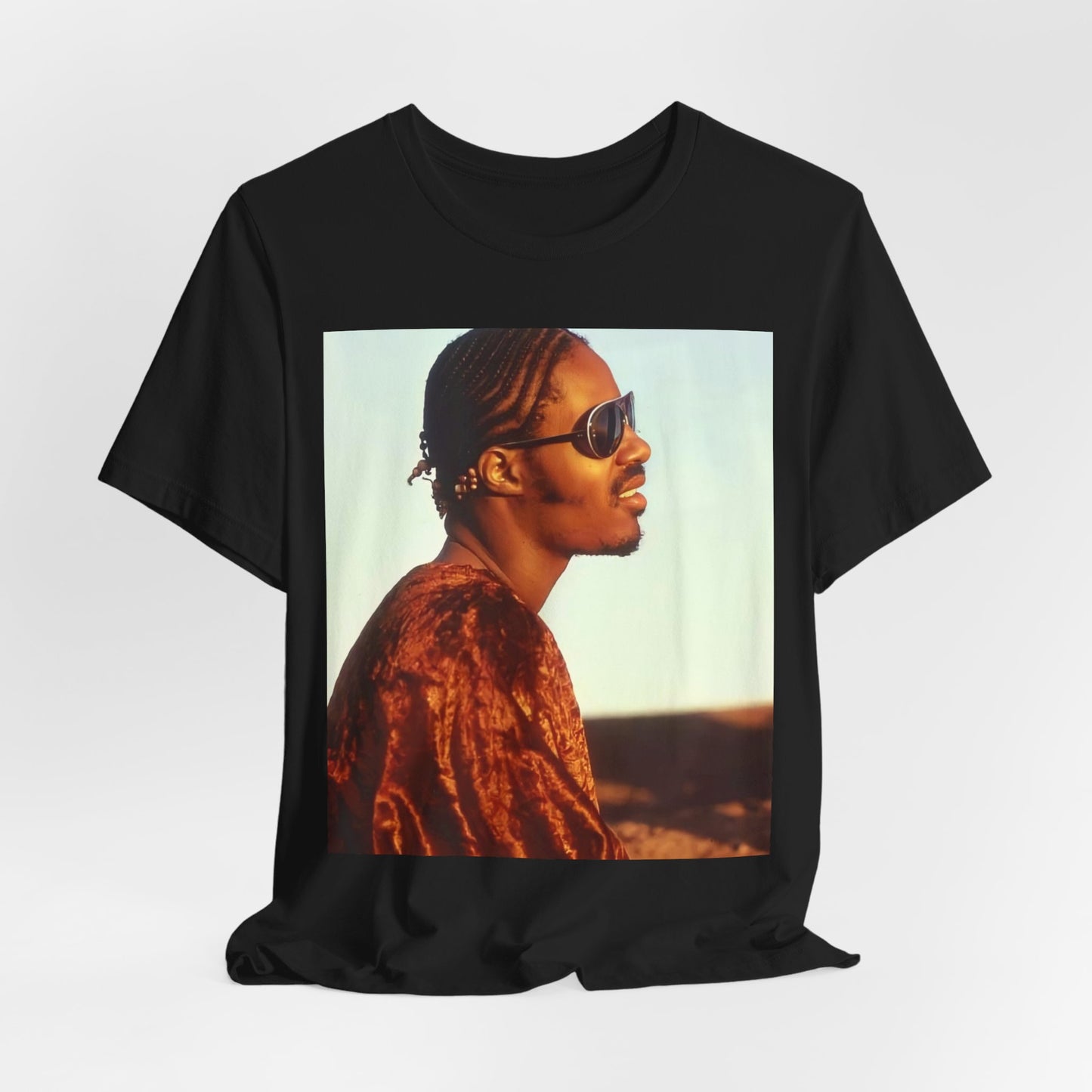 A black graphic t-shirt featuring a graphic of Stevie Wonder as an iconic style pop innovator.