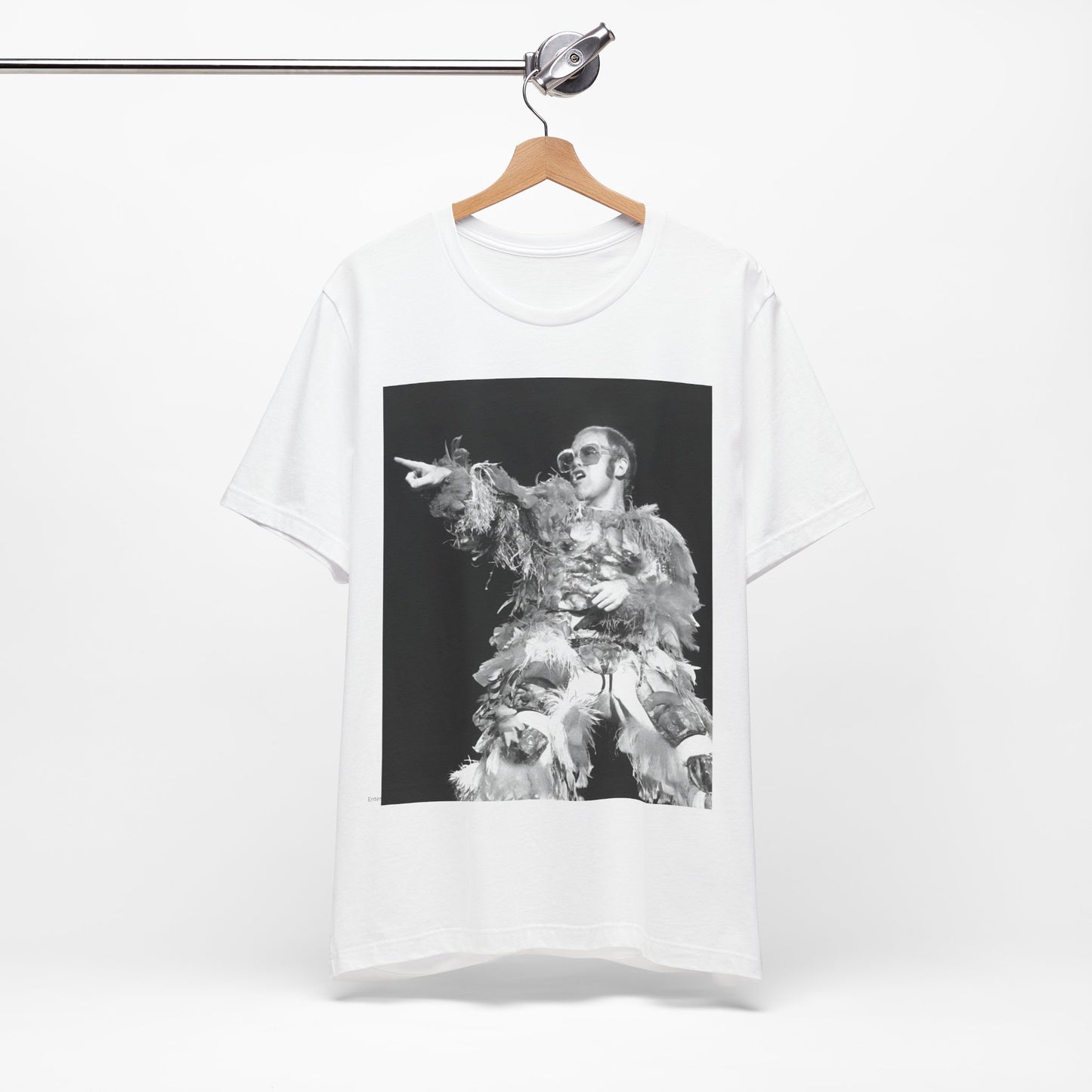A black graphic t-shirt featuring a retro graphic of Elton John as a rock legend performing live.