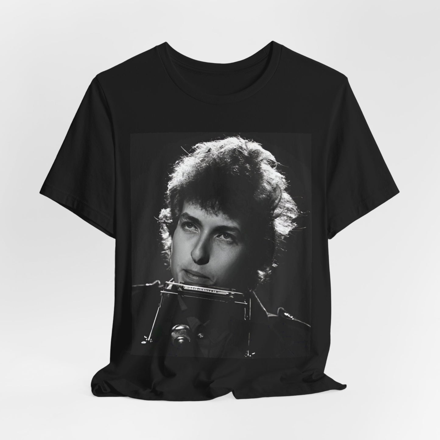 A black graphic t-shirt featuring a graphic of Bob Dylan from the 60s playing his harmonica.