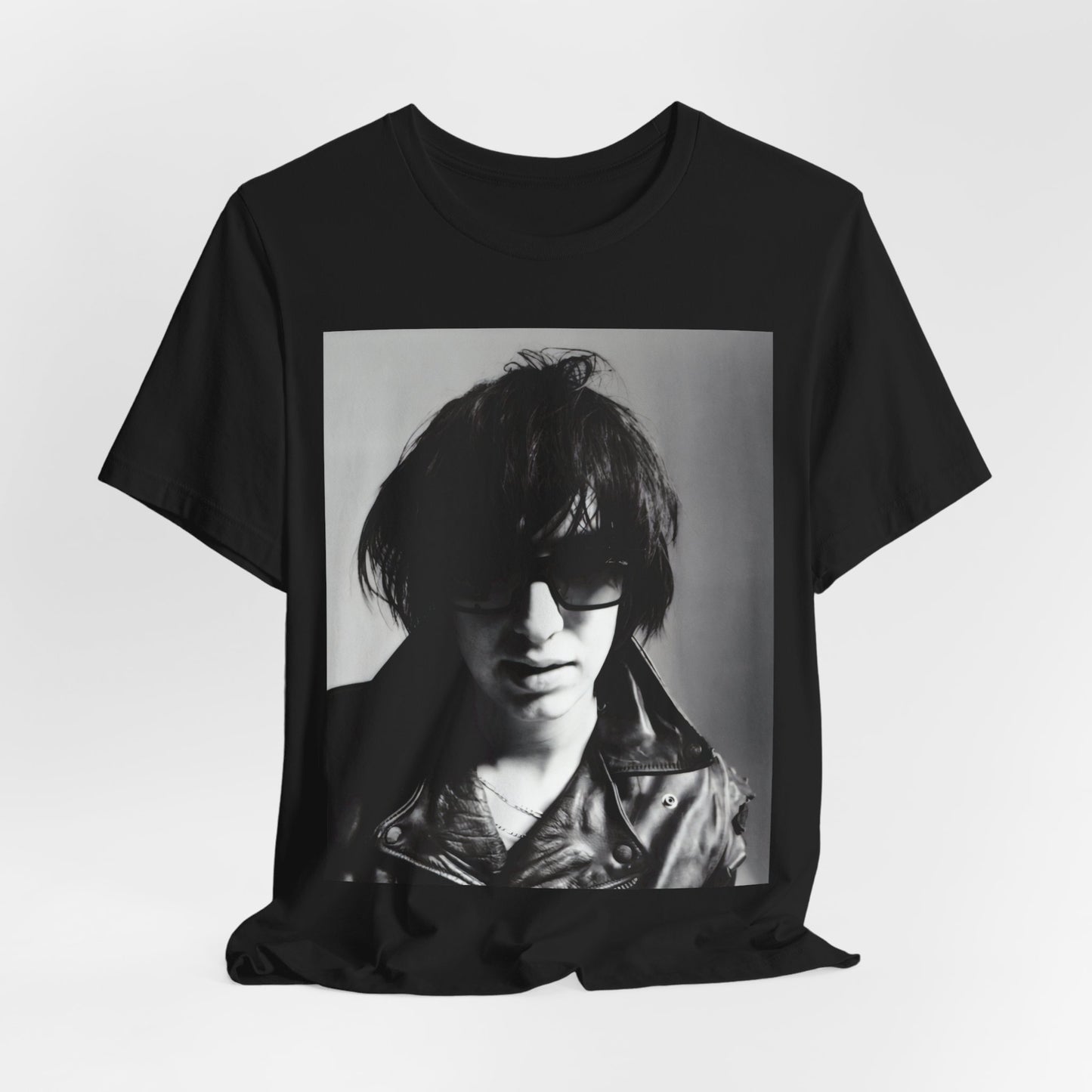 A black graphic t-shirt featuring a graphic related to The Strokes' 'Reptilia' song or era.