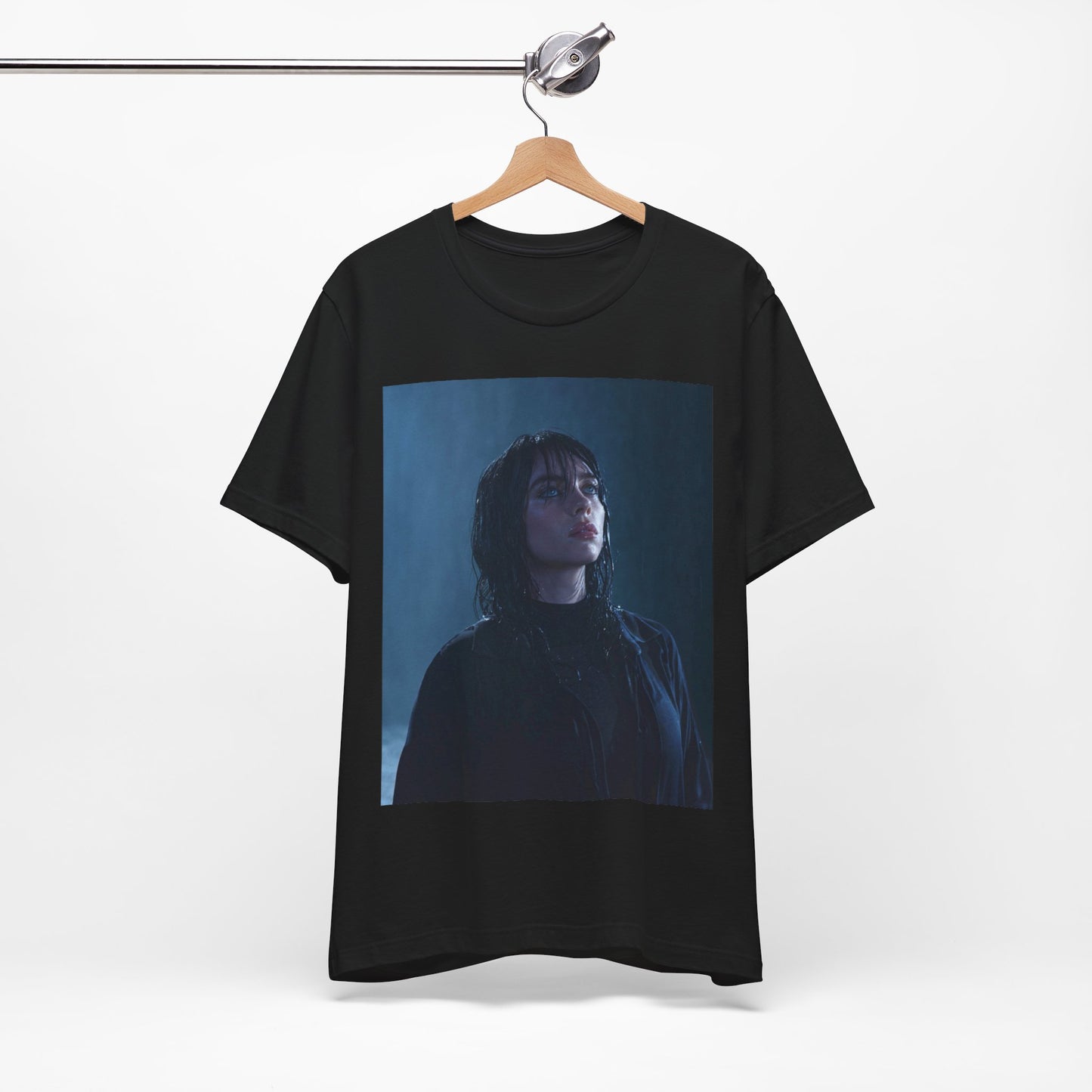 A direct, powerful portrait of Billie Eilish, embodying the 'HIT ME HARD AND SOFT' album era, printed on a graphic t-shirt.