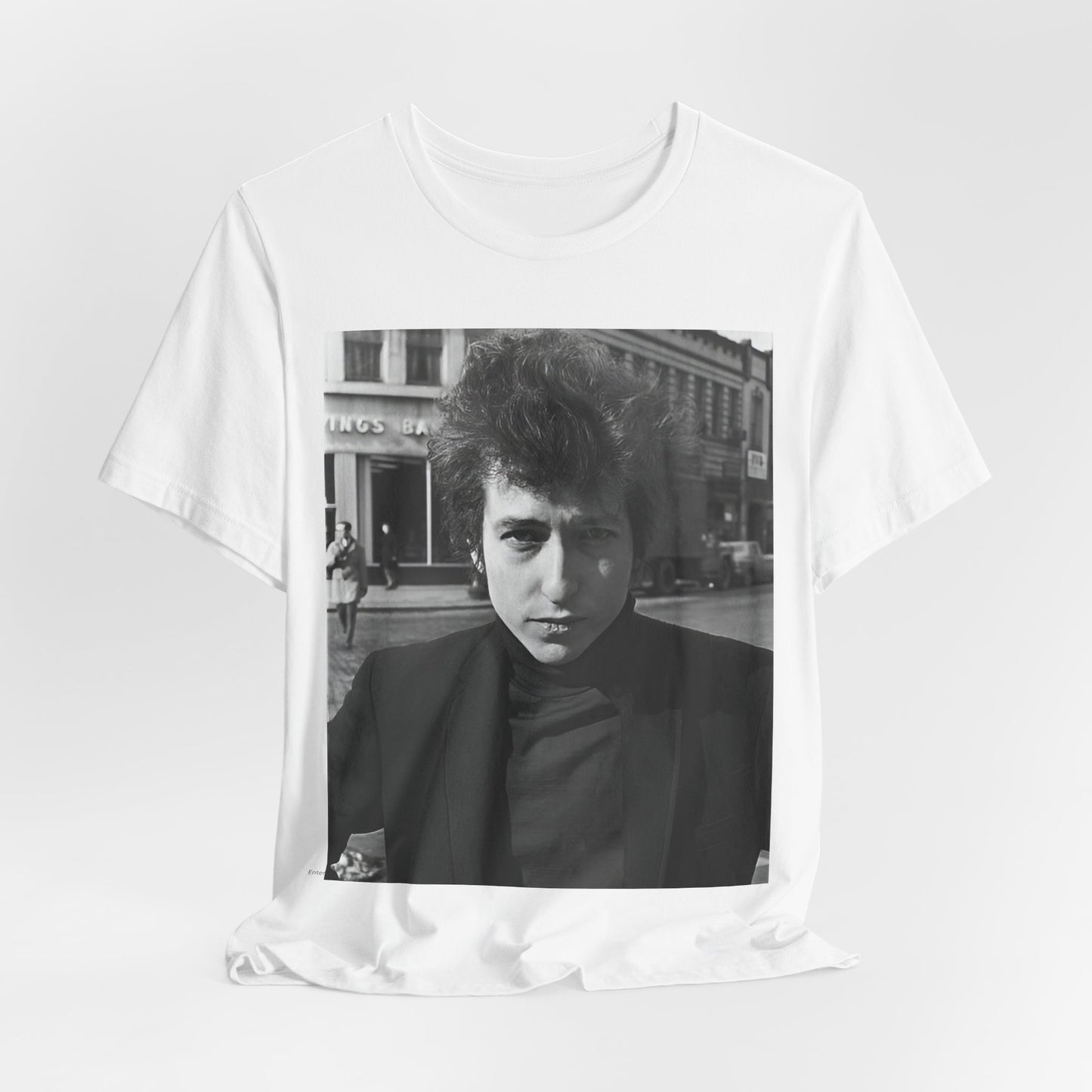 A black graphic t-shirt featuring a 60s black and white photo portrait of Bob Dylan.