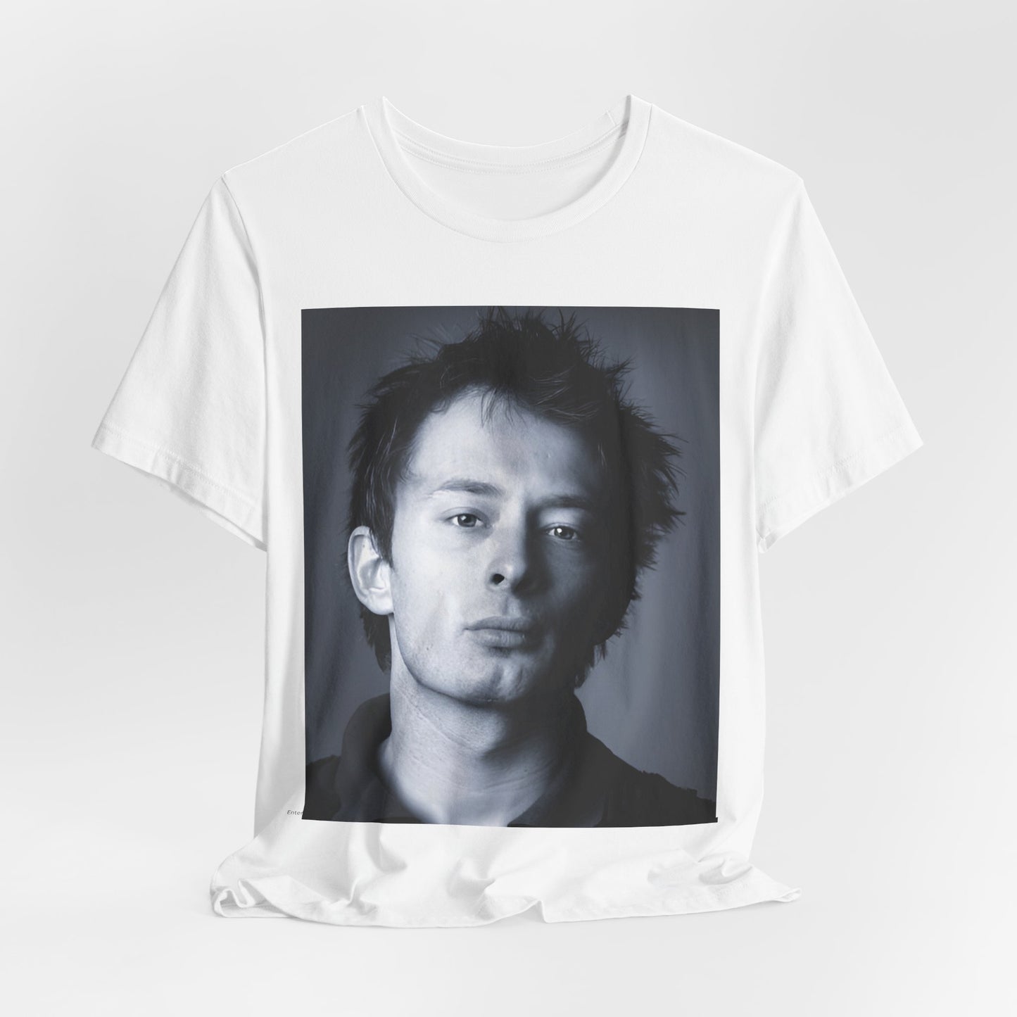 A black graphic t-shirt featuring an enigmatic graphic of Thom Yorke from Radiohead as a frontman.