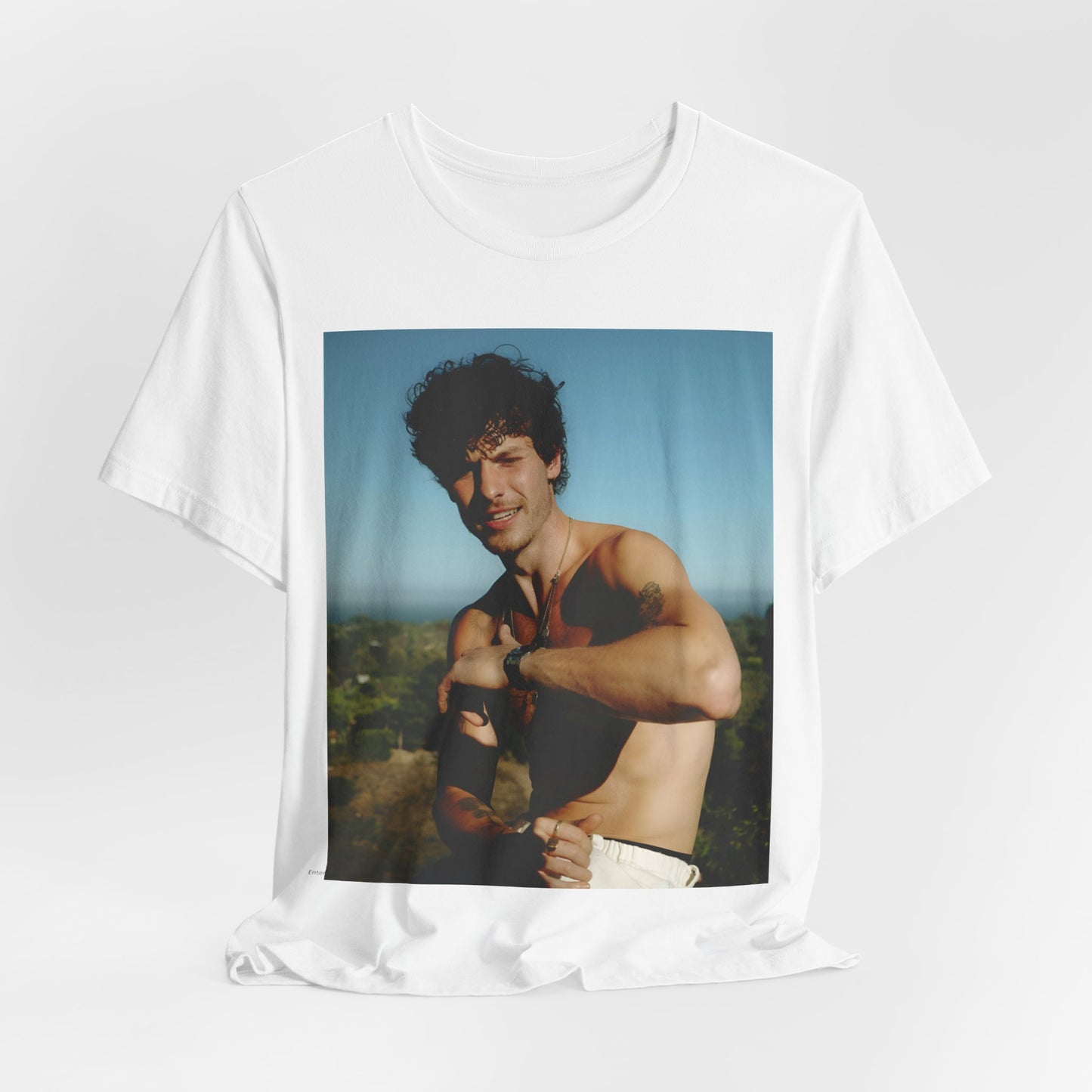 A black graphic t-shirt featuring a graphic of Shawn Mendes with a chill pop star look.
