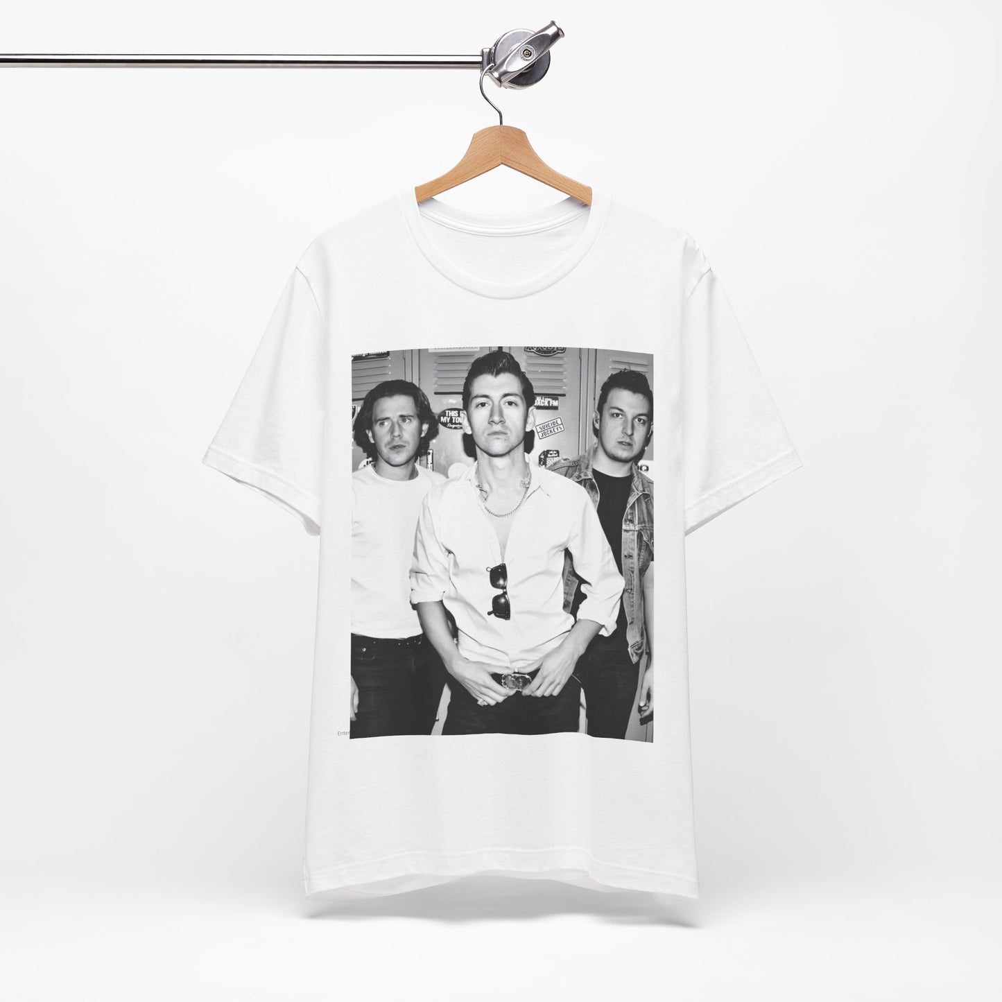 A black graphic t-shirt featuring a vintage-style design related to Arctic Monkeys' 'AM' album era, possibly with the album art or band imagery.