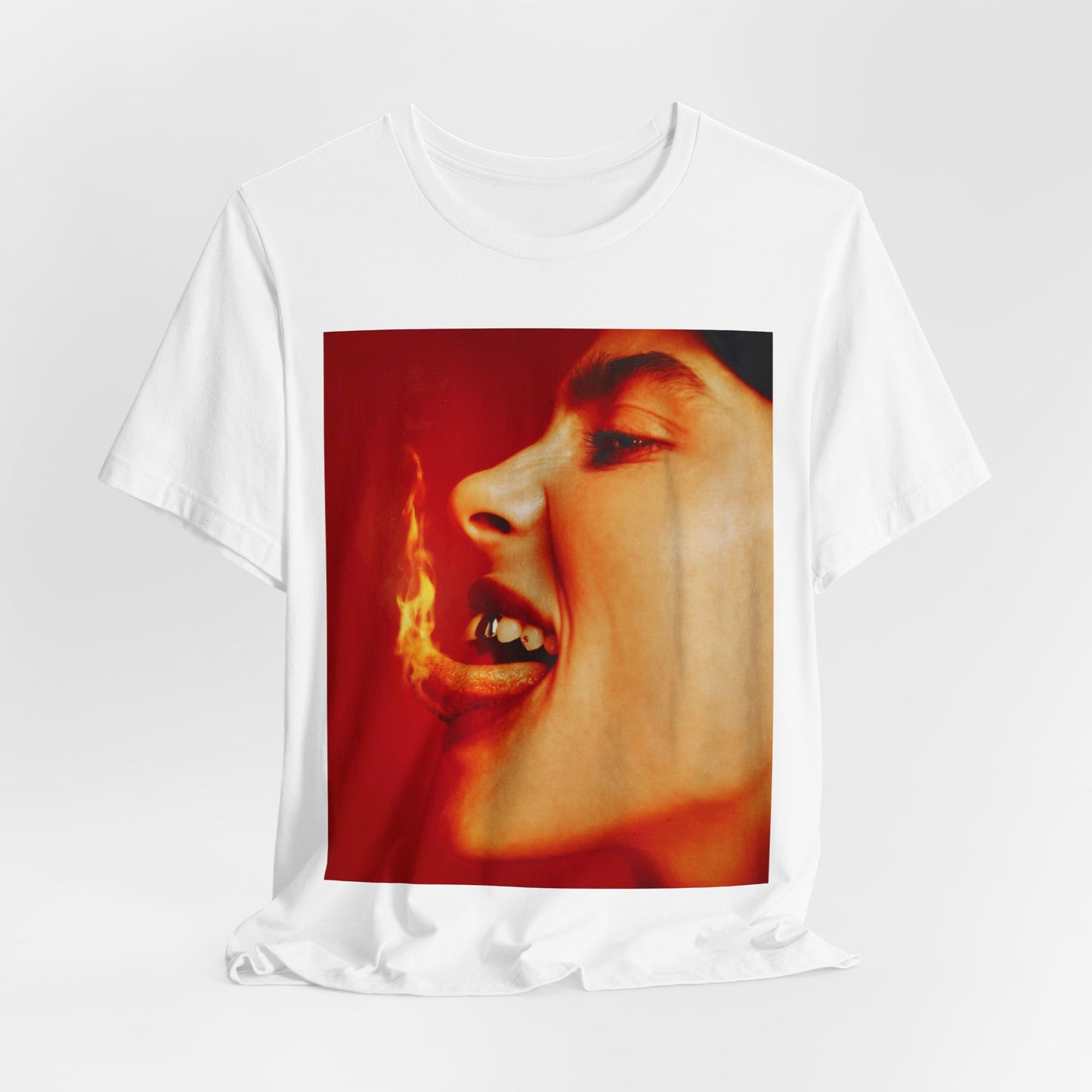 A close-up, red-toned photo of a face in profile with its mouth open and a live flame on the tongue, printed on a graphic t-shirt.