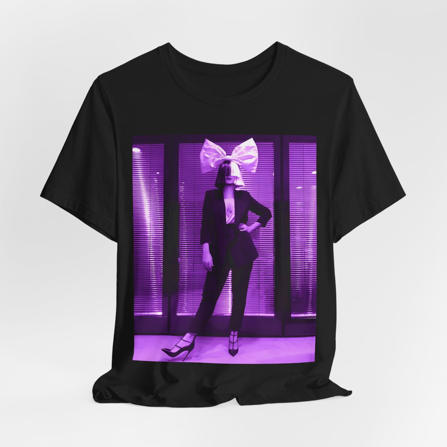 A black graphic t-shirt featuring a vintage pop diva graphic of Sia.