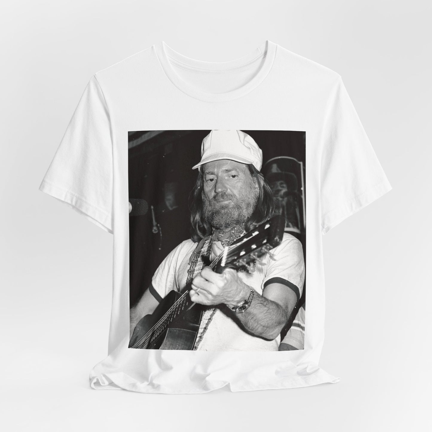 A black graphic t-shirt featuring a 70s cool free spirit graphic of Willie Nelson.