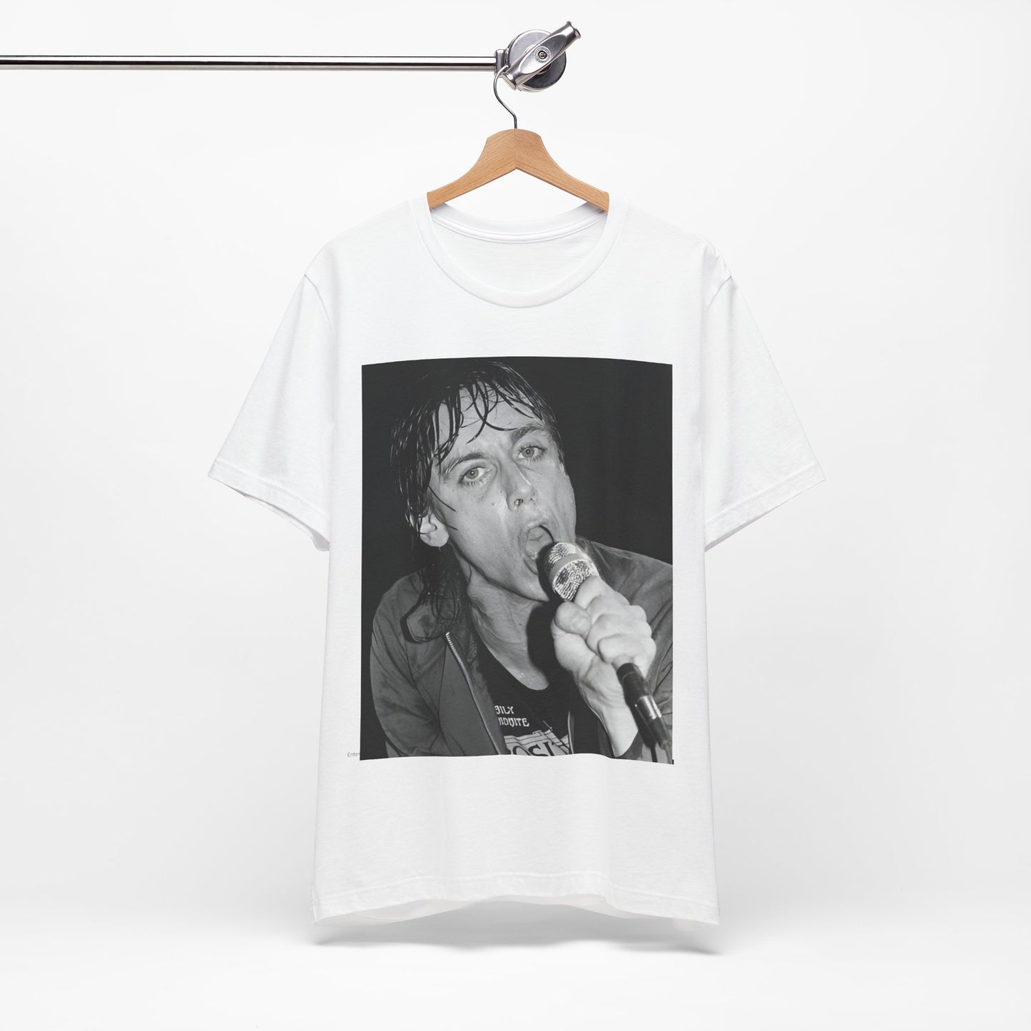 A black graphic t-shirt featuring a 70s graphic or photo of Iggy Pop performing in a wild concert.