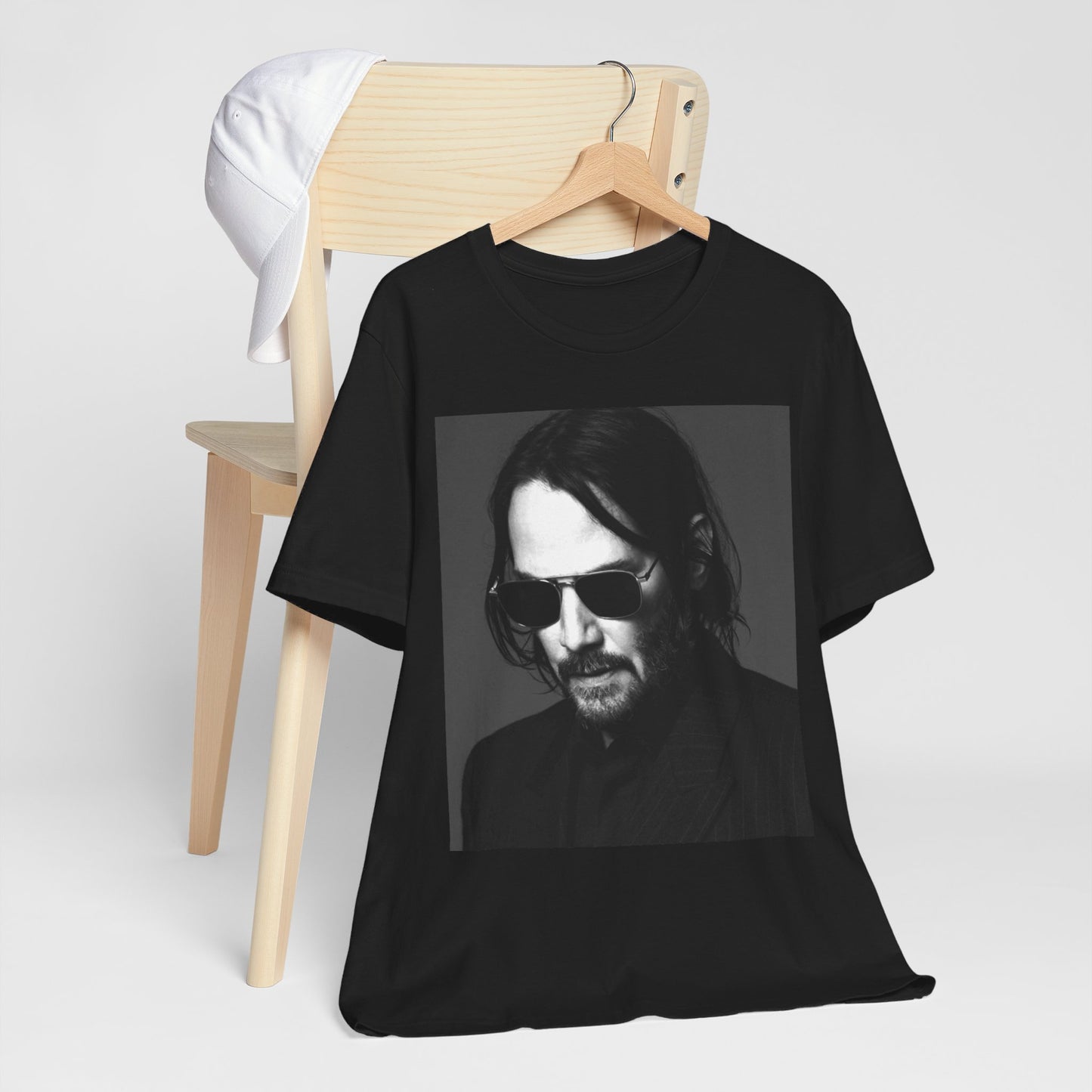 A black graphic t-shirt featuring a graphic of Keanu Reeves with a rebel spirit aesthetic.