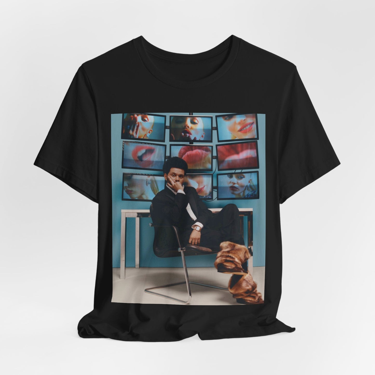 A black graphic t-shirt featuring an aesthetic graphic of The Weeknd.