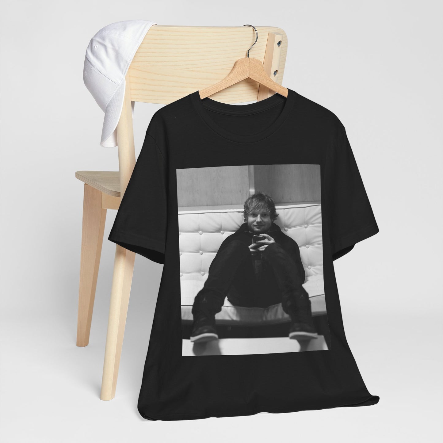 A black graphic t-shirt featuring a bold black and white graphic of Ed Sheeran.
