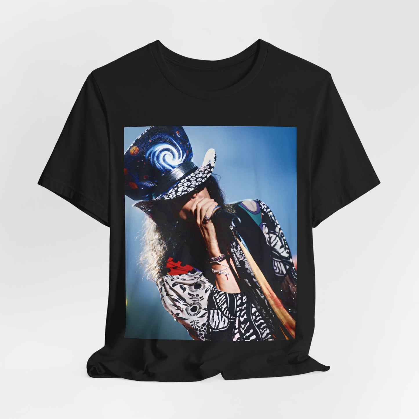 A black graphic t-shirt featuring a vintage 90s photo or illustration of Aerosmith performing live on stage, with band members in dynamic poses.
