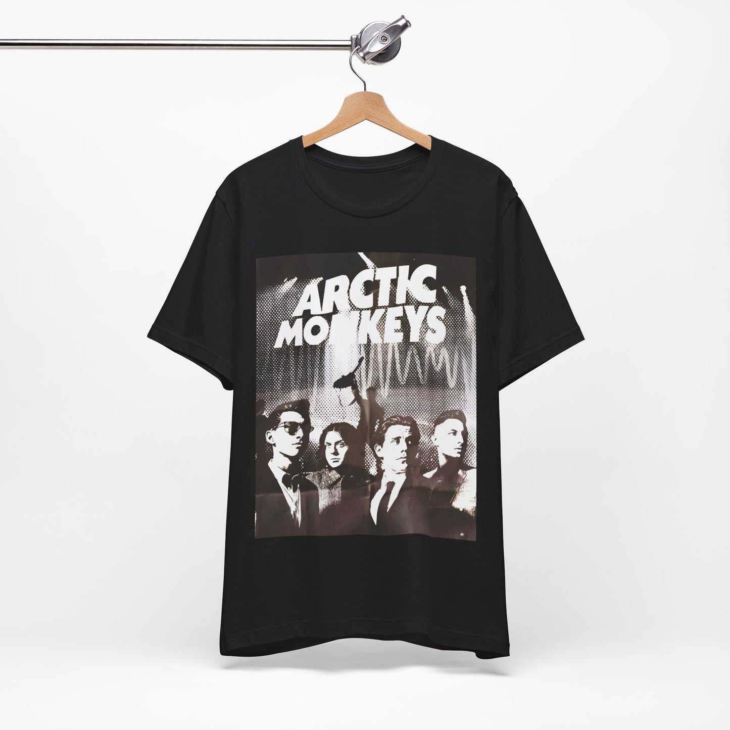 A black graphic t-shirt featuring a retro-style logo for the band Arctic Monkeys.