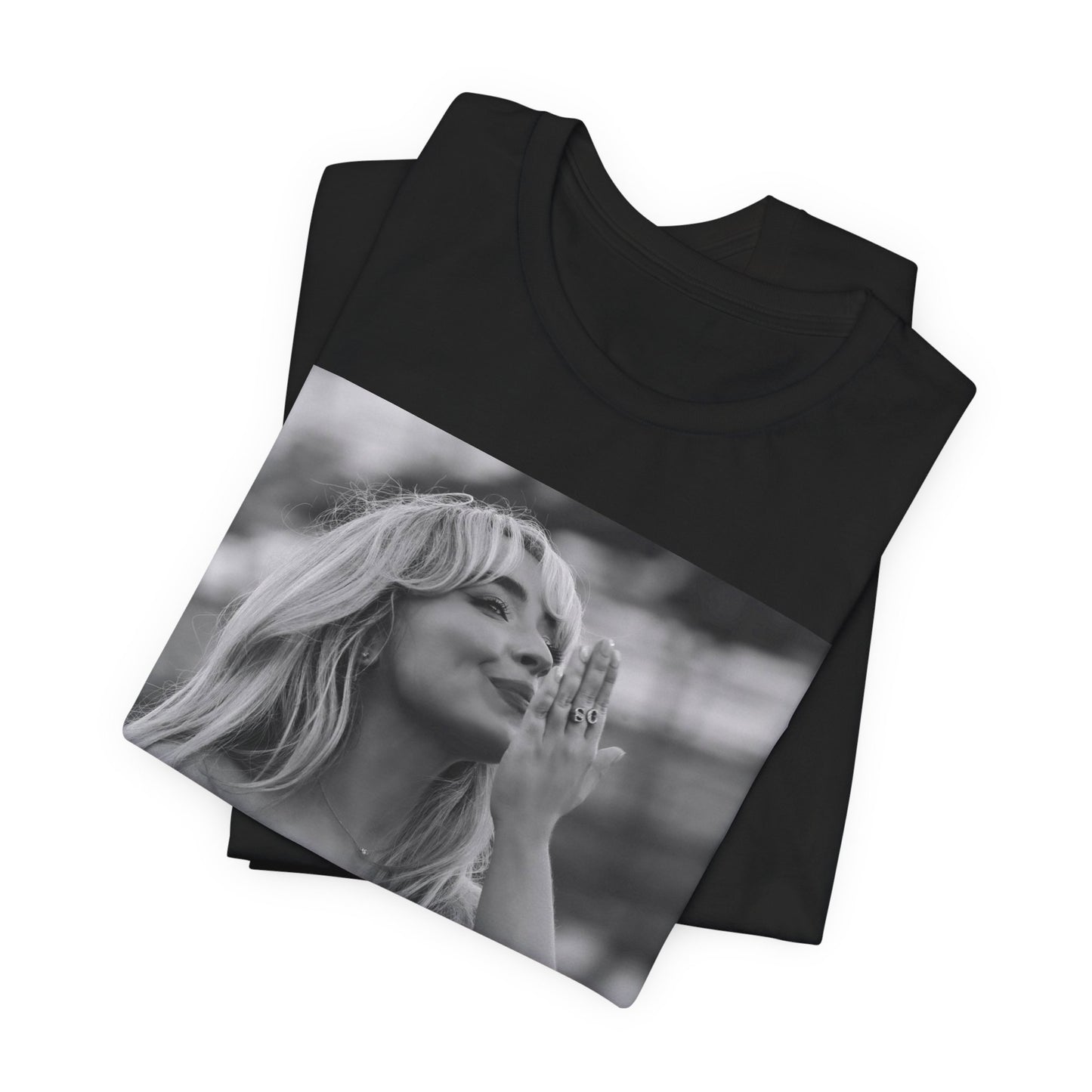 A black graphic t-shirt featuring a graphic or photo of Sabrina Carpenter kissing on stage during a performance.