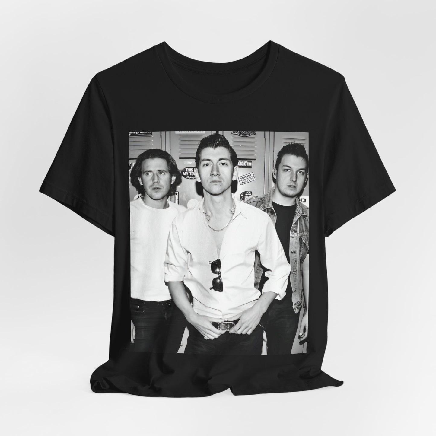 A black graphic t-shirt featuring a vintage-style design related to Arctic Monkeys' 'AM' album era, possibly with the album art or band imagery.