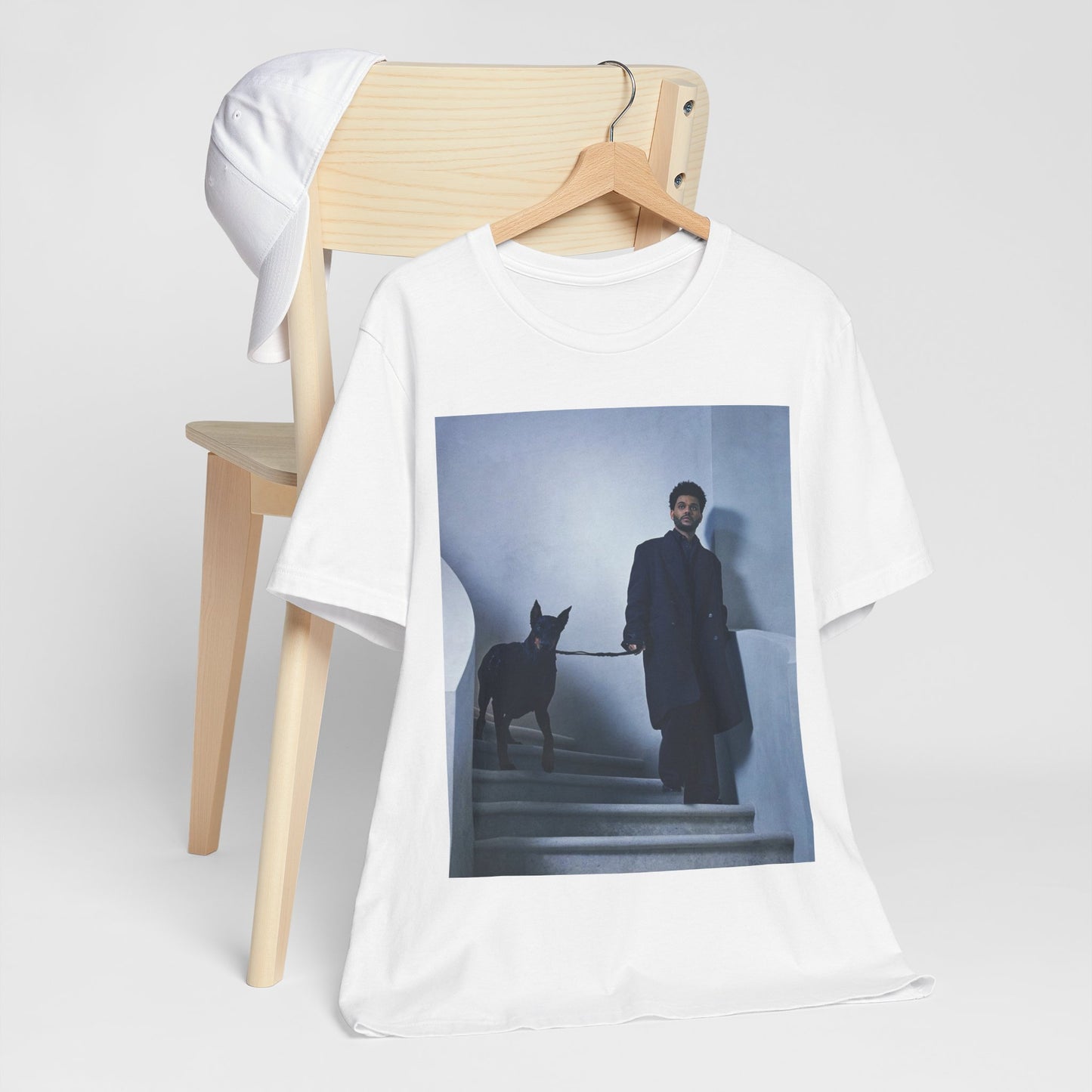 A black graphic t-shirt featuring a photo of The Weeknd with a doberman.