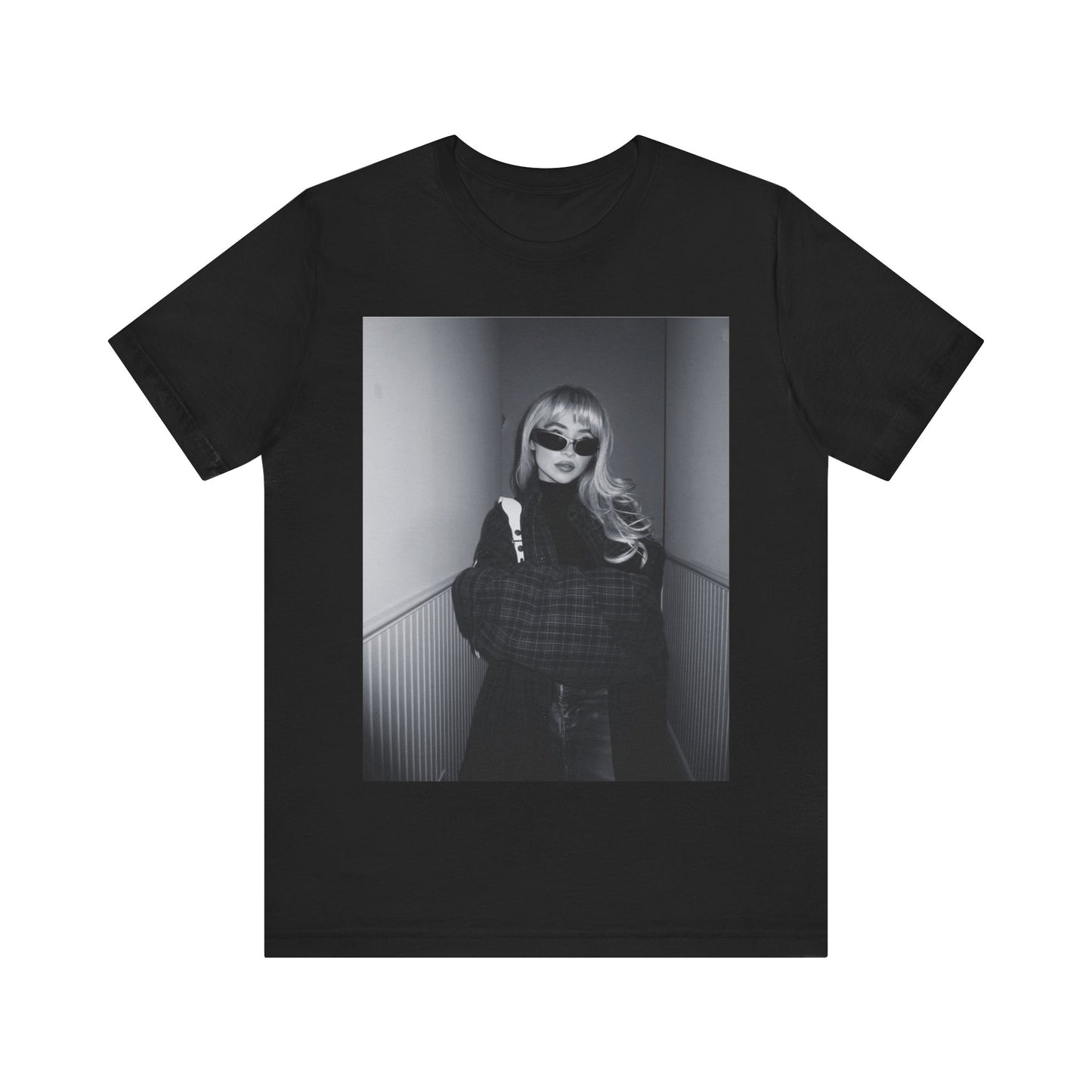 A black graphic t-shirt featuring a black and white glam pop diva graphic of Sabrina Carpenter.