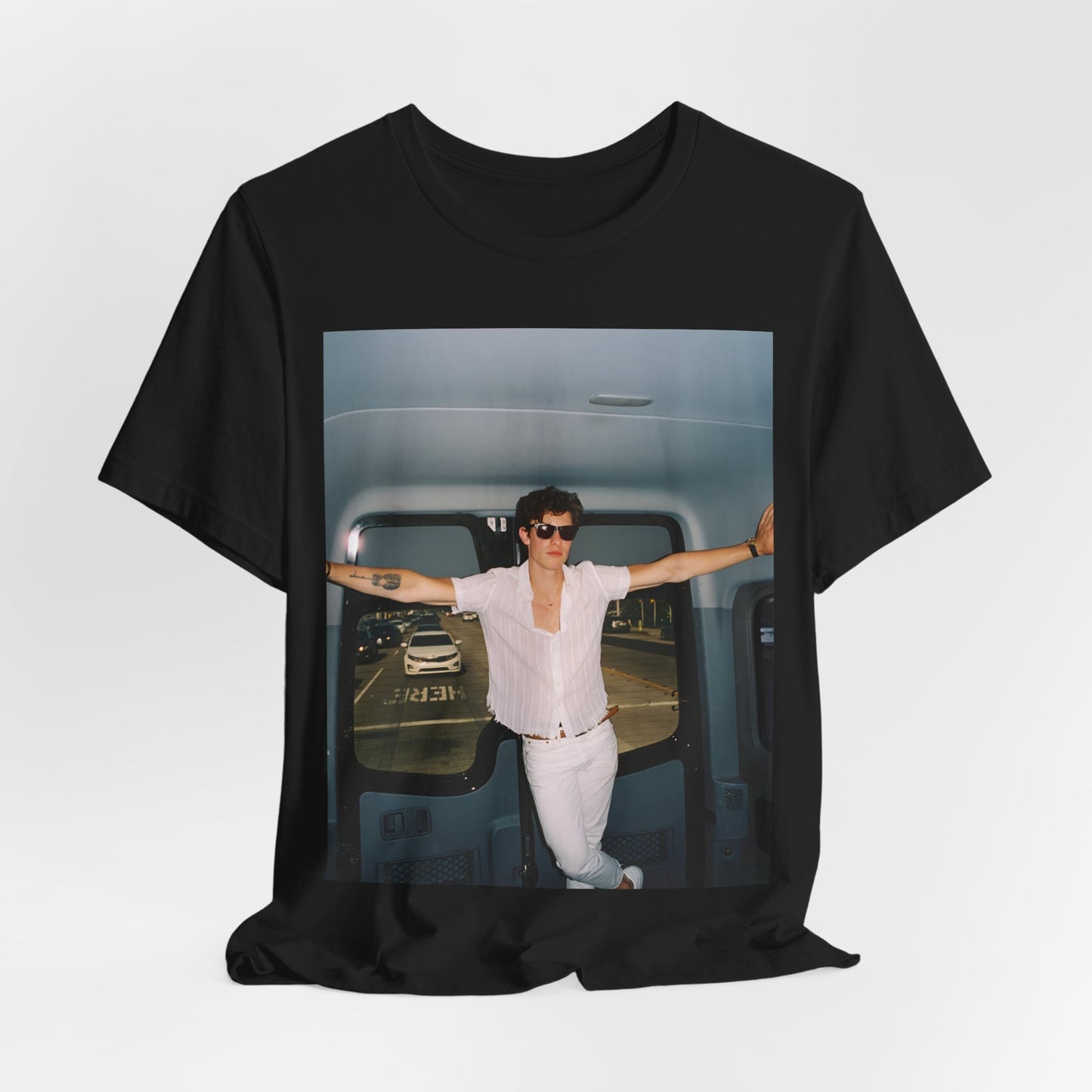 A black graphic t-shirt featuring a graphic of Shawn Mendes with a classic confident look.