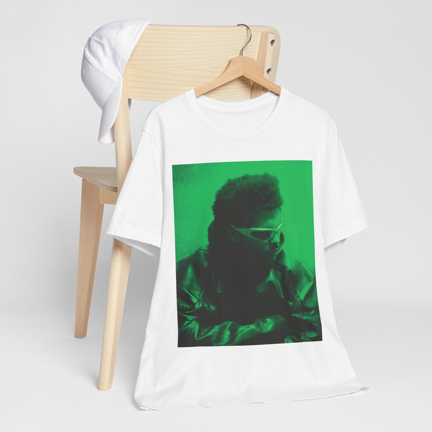A black graphic t-shirt featuring a vintage graphic related to The Weeknd's 'Kiss Land' era.