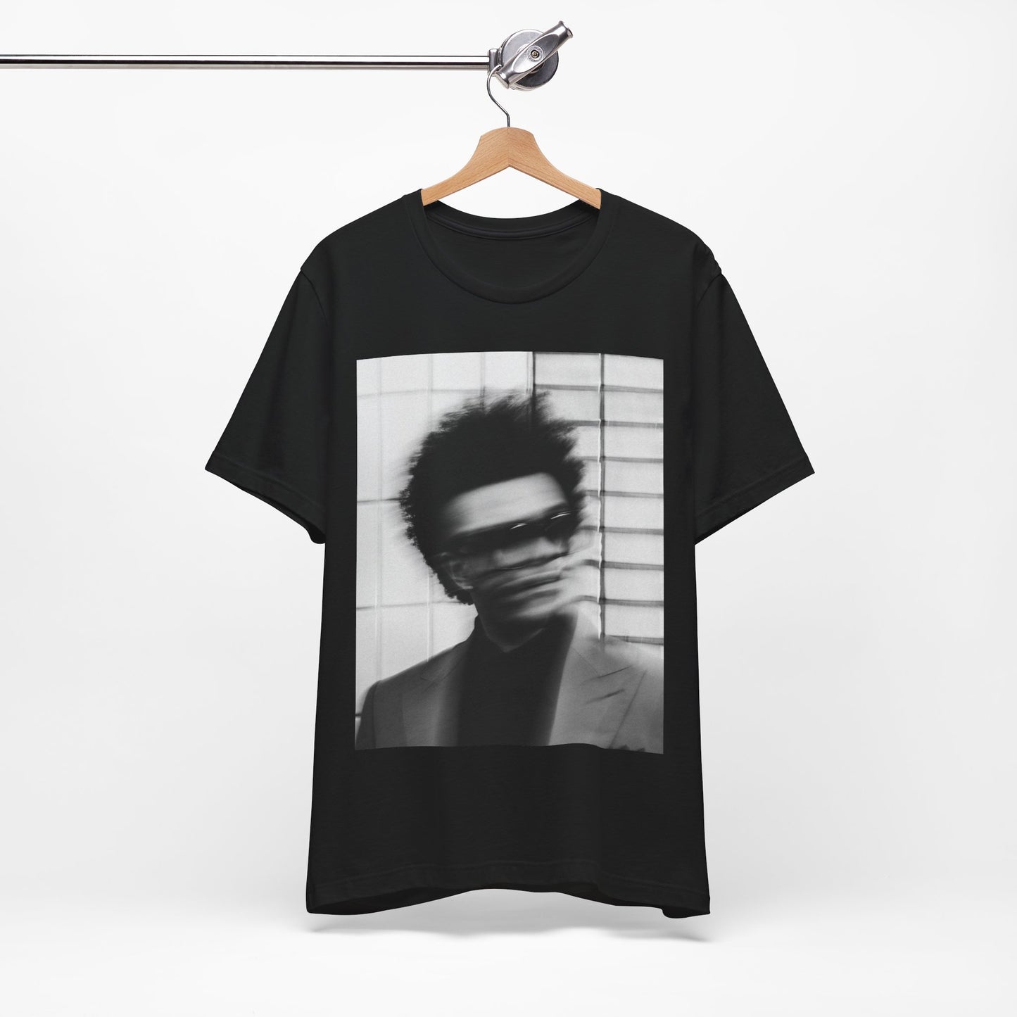 A black graphic t-shirt featuring a blurred graphic of The Weeknd from his 'After Hours' era.