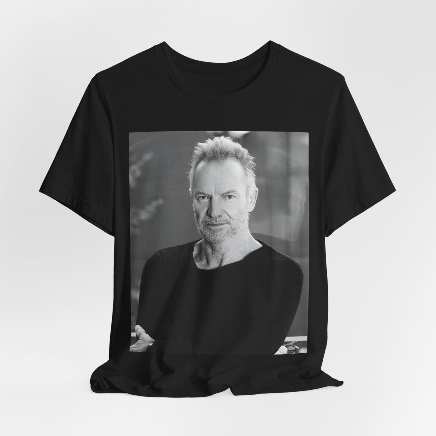 A black graphic t-shirt featuring a vintage graphic related to Sting's 'Desert Rose' song or era.