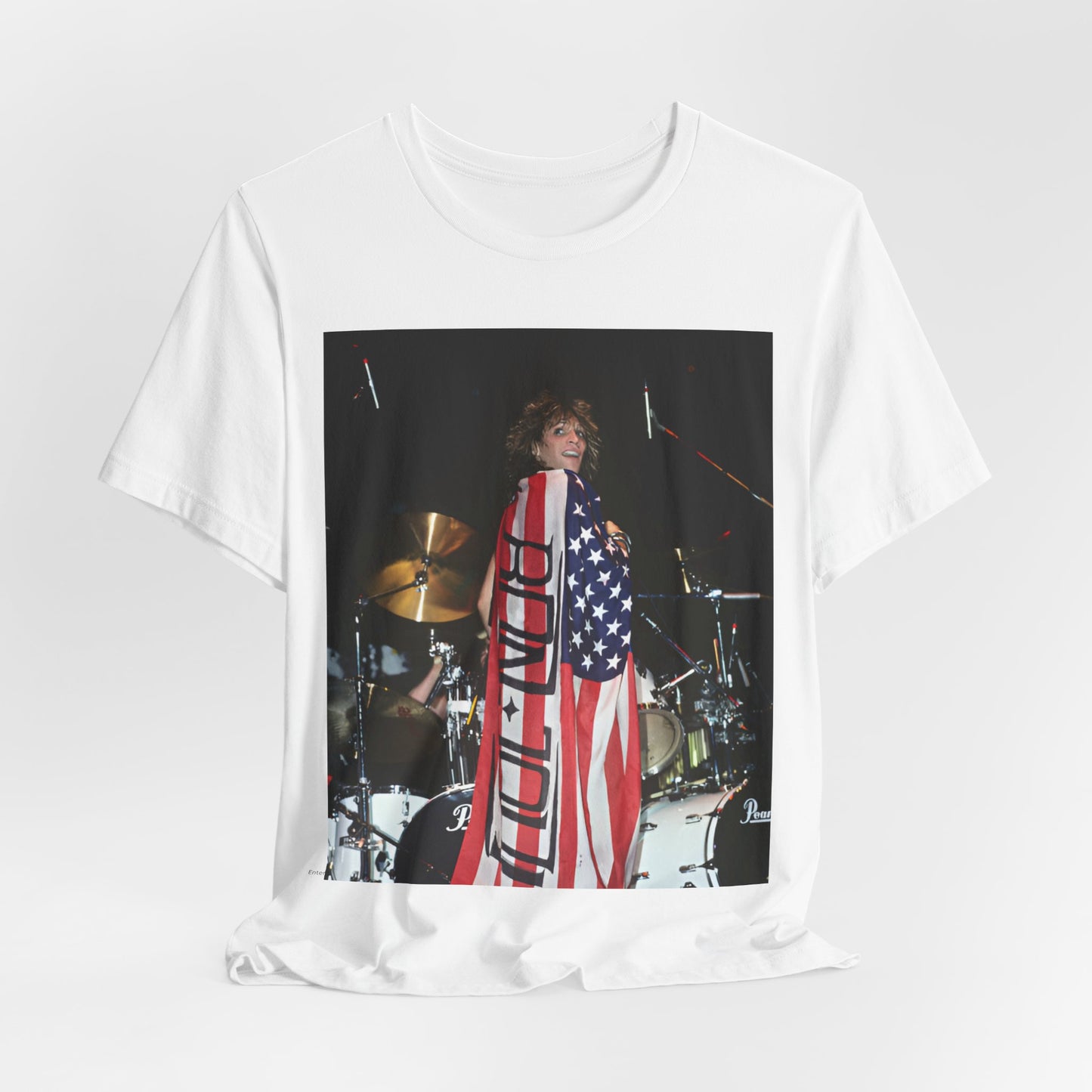 A black graphic t-shirt featuring a graphic of Bon Jovi performing on stage with an American flag as a backdrop.