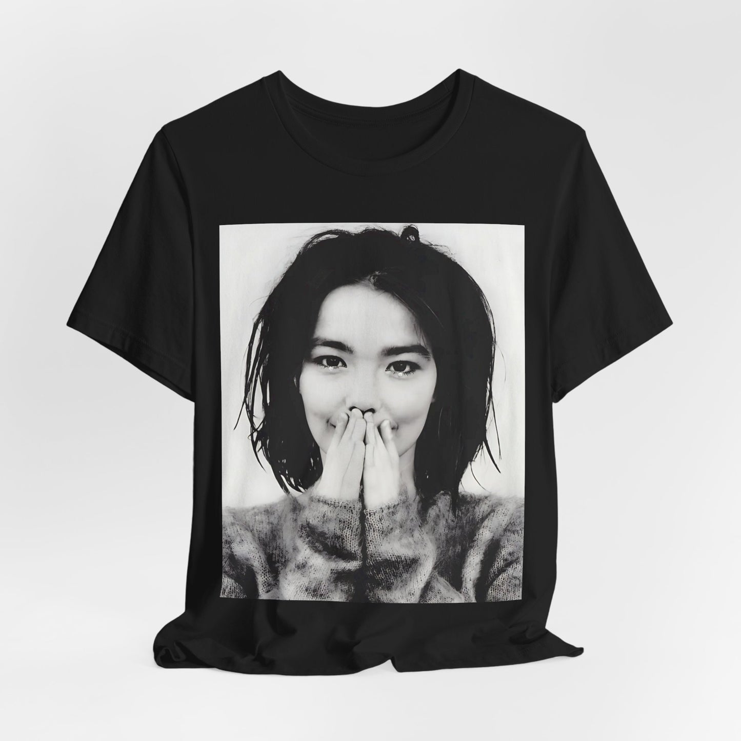 A black graphic t-shirt featuring a 90s black and white photographic portrait of Bjork.