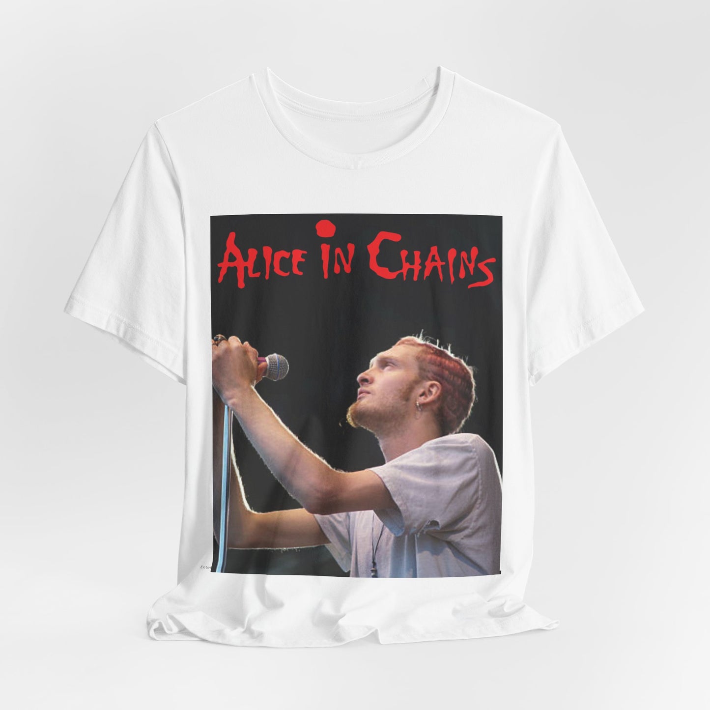 A black graphic t-shirt featuring the Alice In Chains logo in red, in a 90s grunge style.