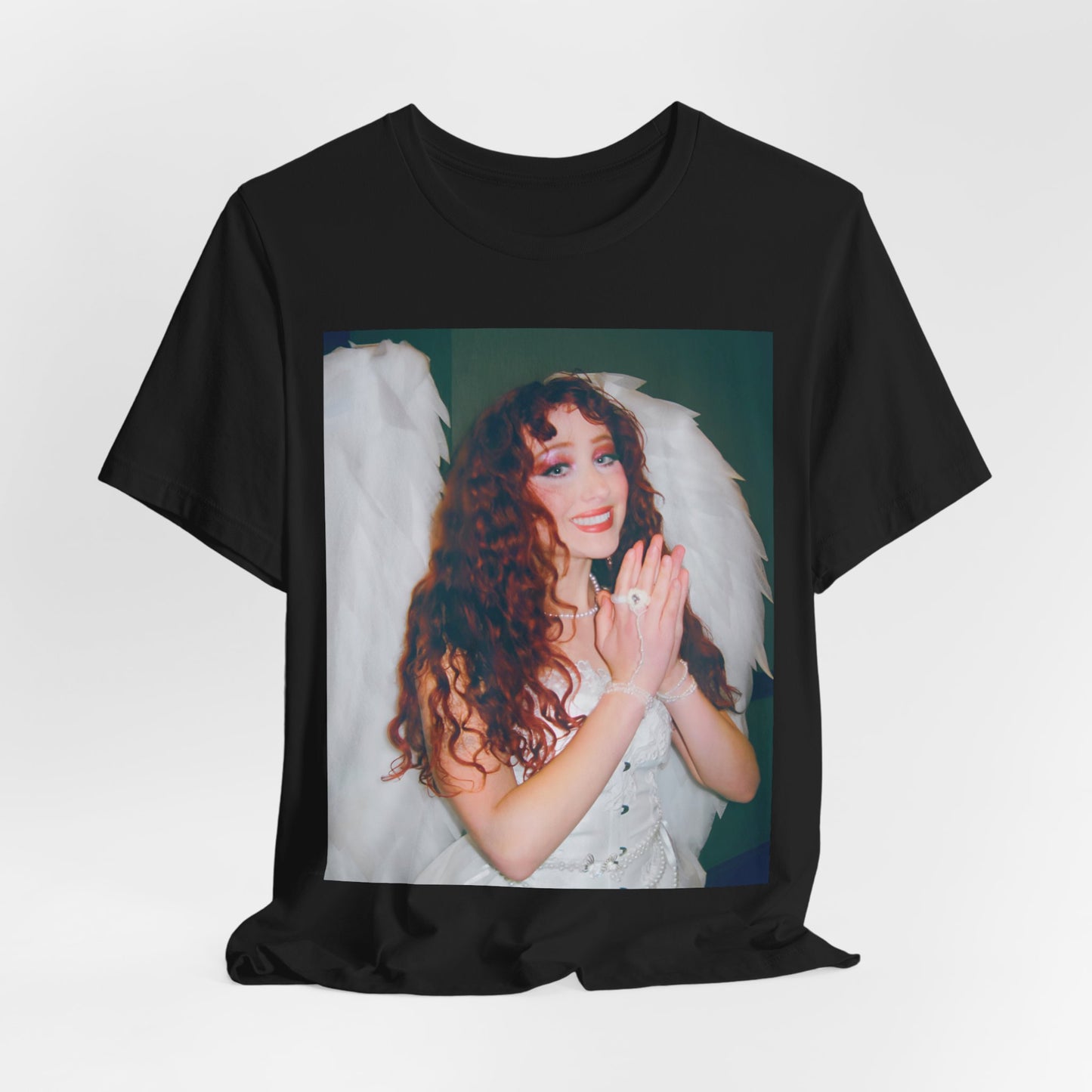 A black graphic t-shirt featuring a graphic of Chappell Roan, possibly with DIY or independent pop elements.