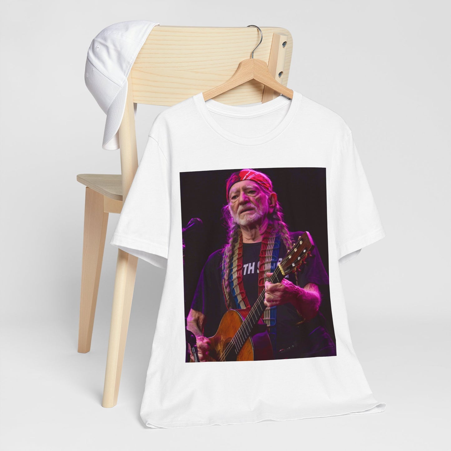 A black graphic t-shirt featuring an outlaw country legend graphic of Willie Nelson.