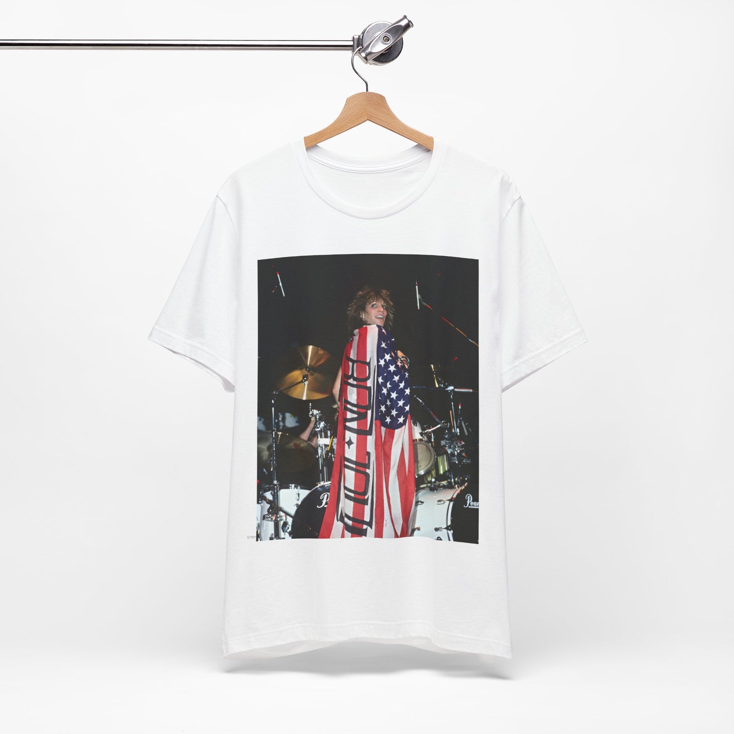 A black graphic t-shirt featuring a graphic of Bon Jovi performing on stage with an American flag as a backdrop.