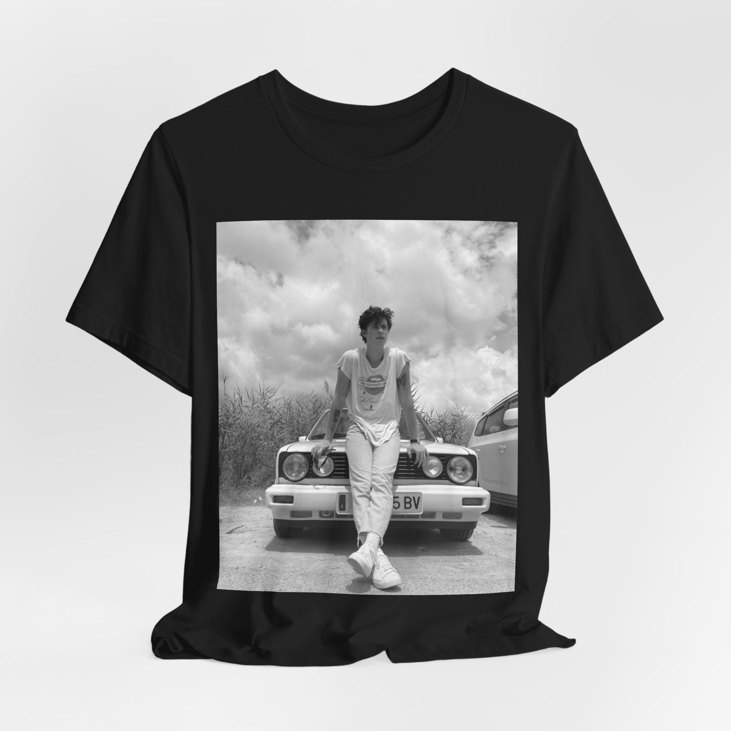 A black graphic t-shirt featuring a graphic of Shawn Mendes in an iconic tank top look.