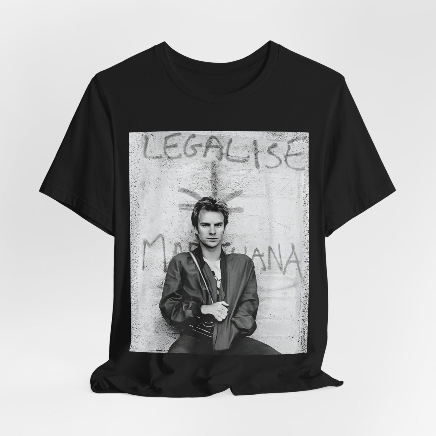 A black graphic t-shirt featuring a graphic of The Police with reggae-influenced pop elements.