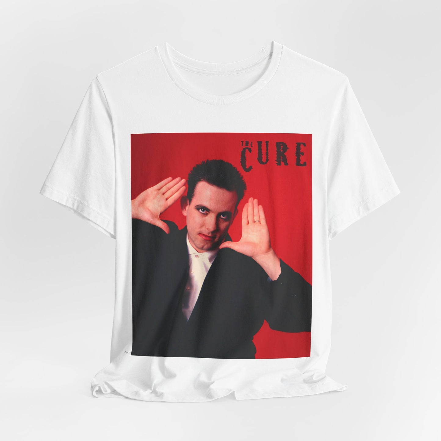 A black graphic t-shirt featuring a graphic of Robert Smith from The Cure in his authentic style.