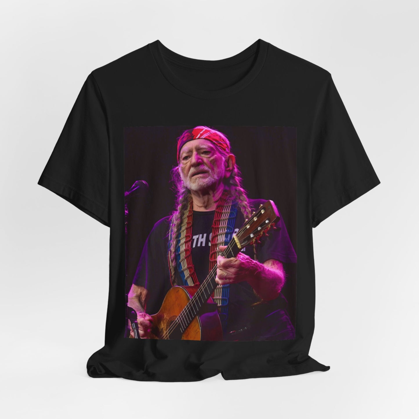 A black graphic t-shirt featuring an outlaw country legend graphic of Willie Nelson.