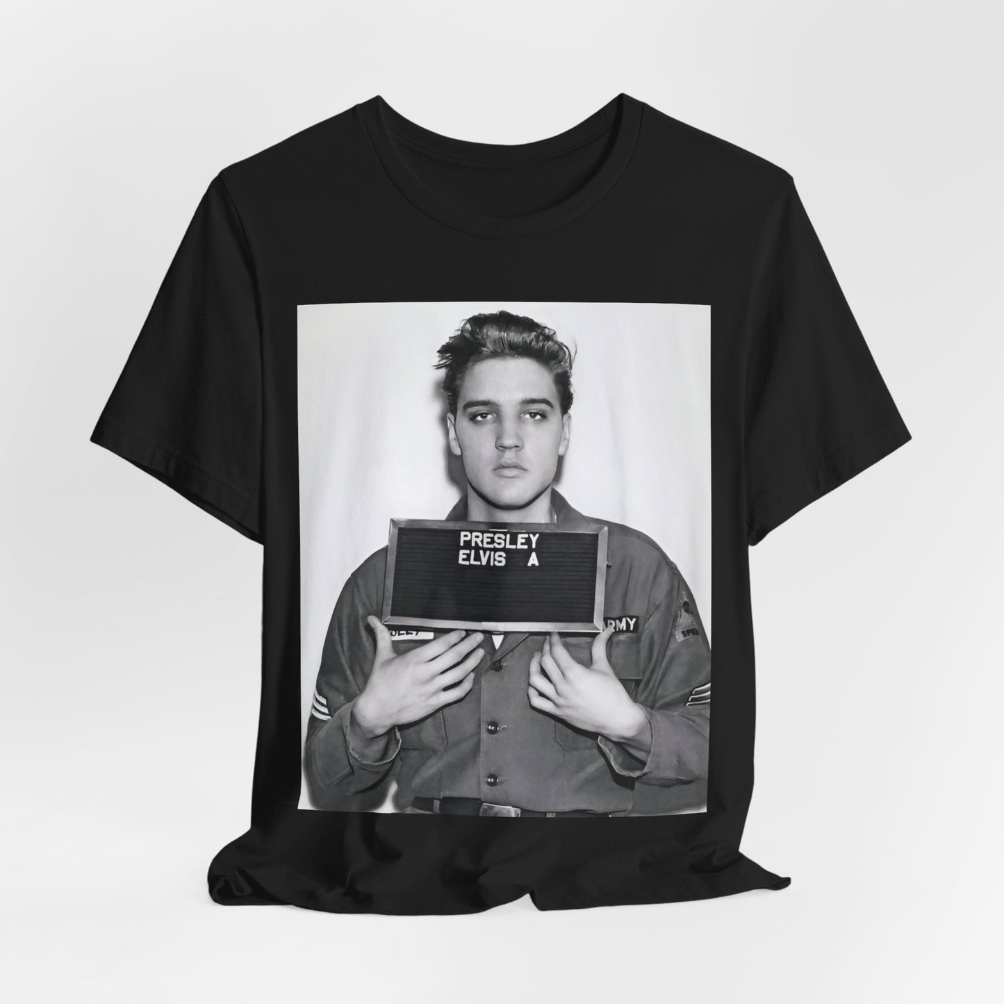 A black graphic t-shirt featuring a retro mugshot photo of Elvis Presley.