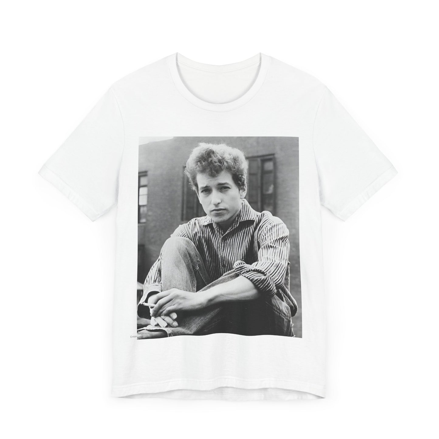 A black graphic t-shirt featuring a graphic of Bob Dylan from his 60s origins in folk music.