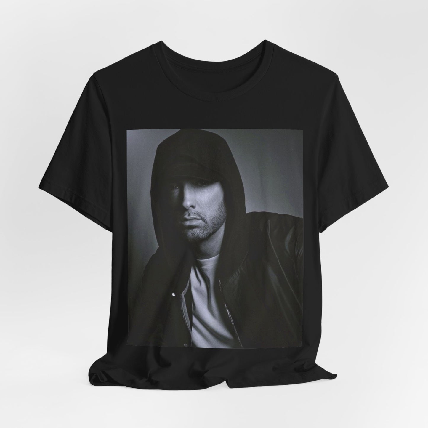 A black graphic t-shirt featuring a black and white, monochrome graphic or photo of Eminem.