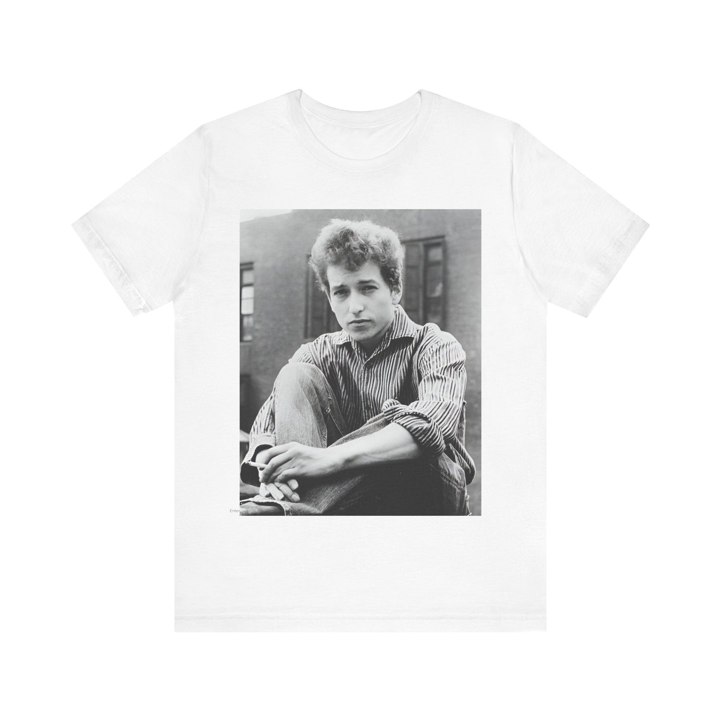 A black graphic t-shirt featuring a graphic of Bob Dylan from his 60s origins in folk music.