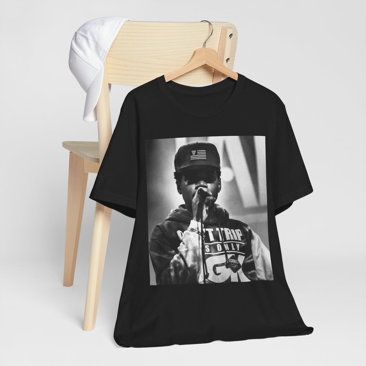 A black graphic t-shirt featuring a vintage-style graphic or photo of Chance the Rapper performing live.
