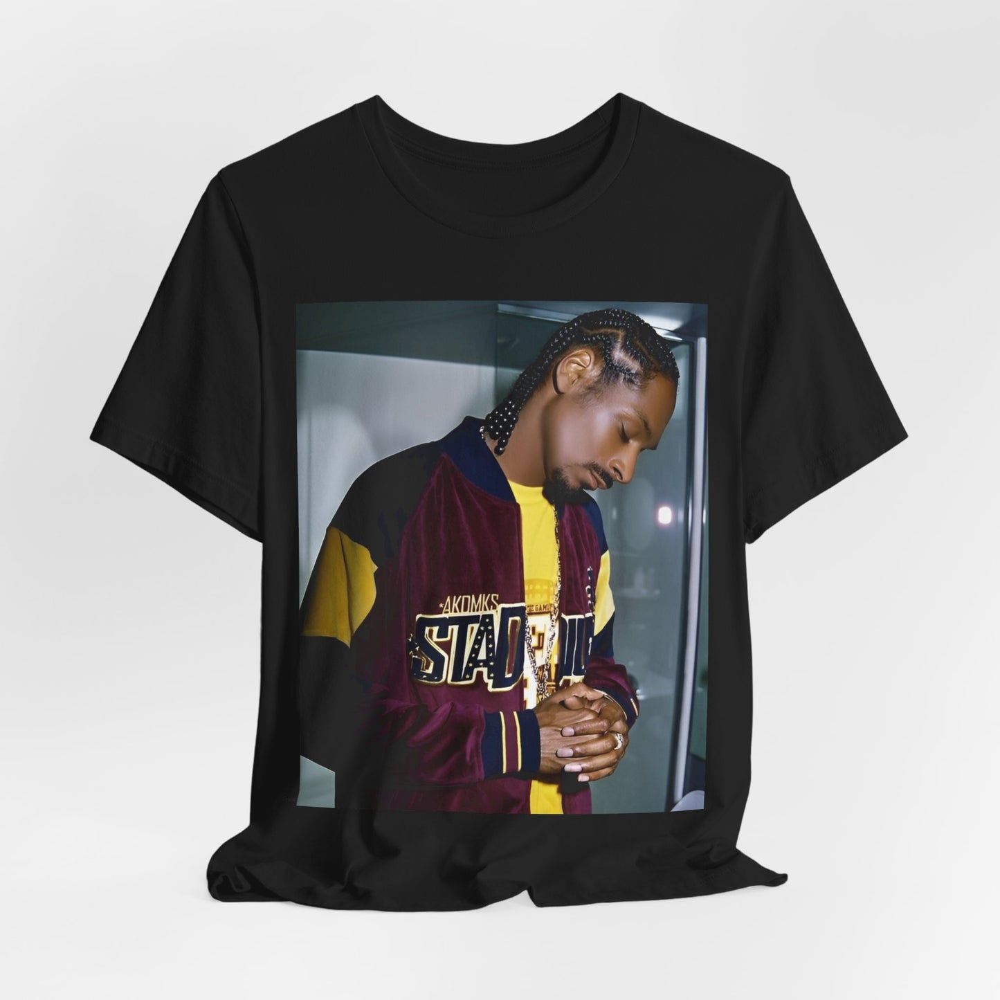 A black graphic t-shirt featuring a classic graphic of Snoop Dogg with a cool gaze.