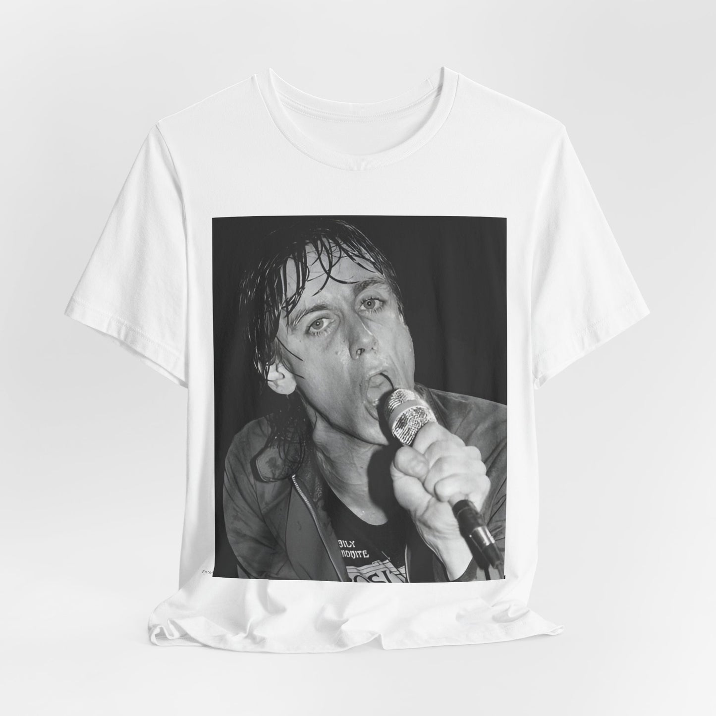 A black graphic t-shirt featuring a 70s graphic or photo of Iggy Pop performing in a wild concert.