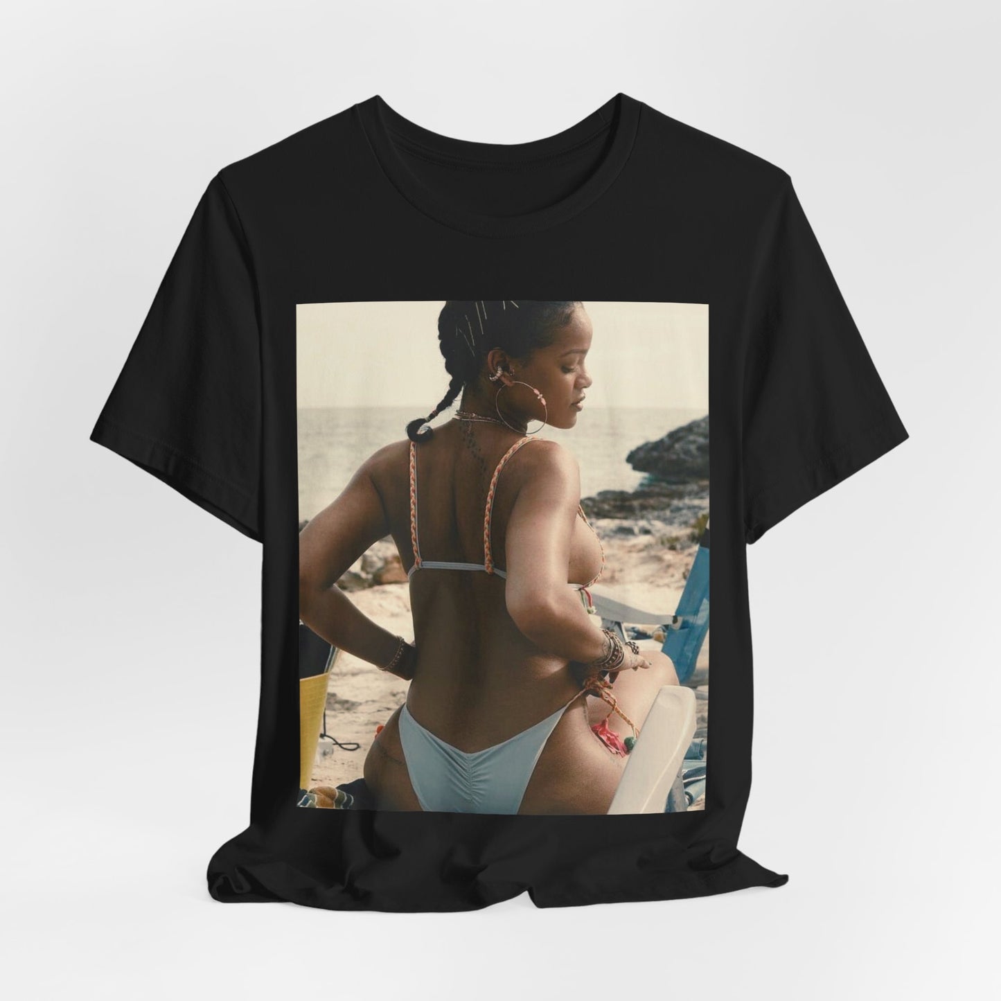 A black graphic t-shirt featuring a graphic of Rihanna as a bikini babe in paradise.