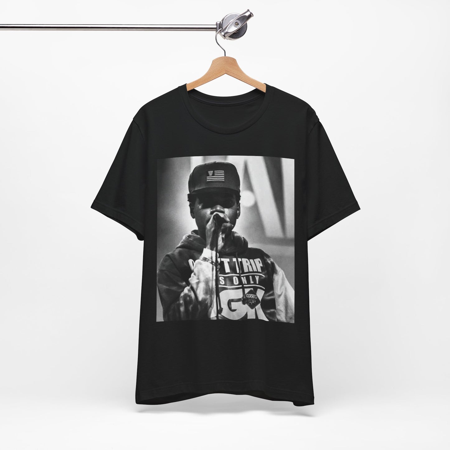 A black graphic t-shirt featuring a vintage-style graphic or photo of Chance the Rapper performing live.