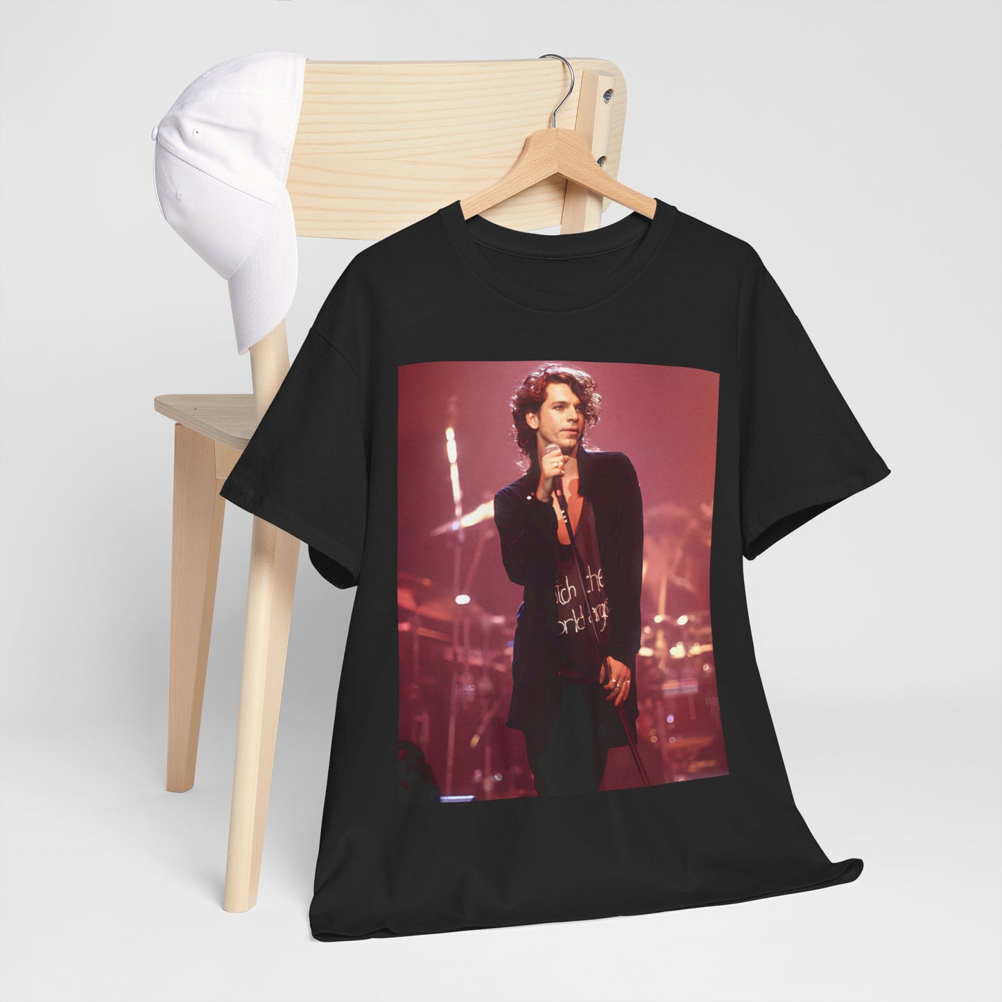 A black graphic t-shirt featuring a graphic related to INXS's 'Never Tear Us Apart' song or era from the 90s.