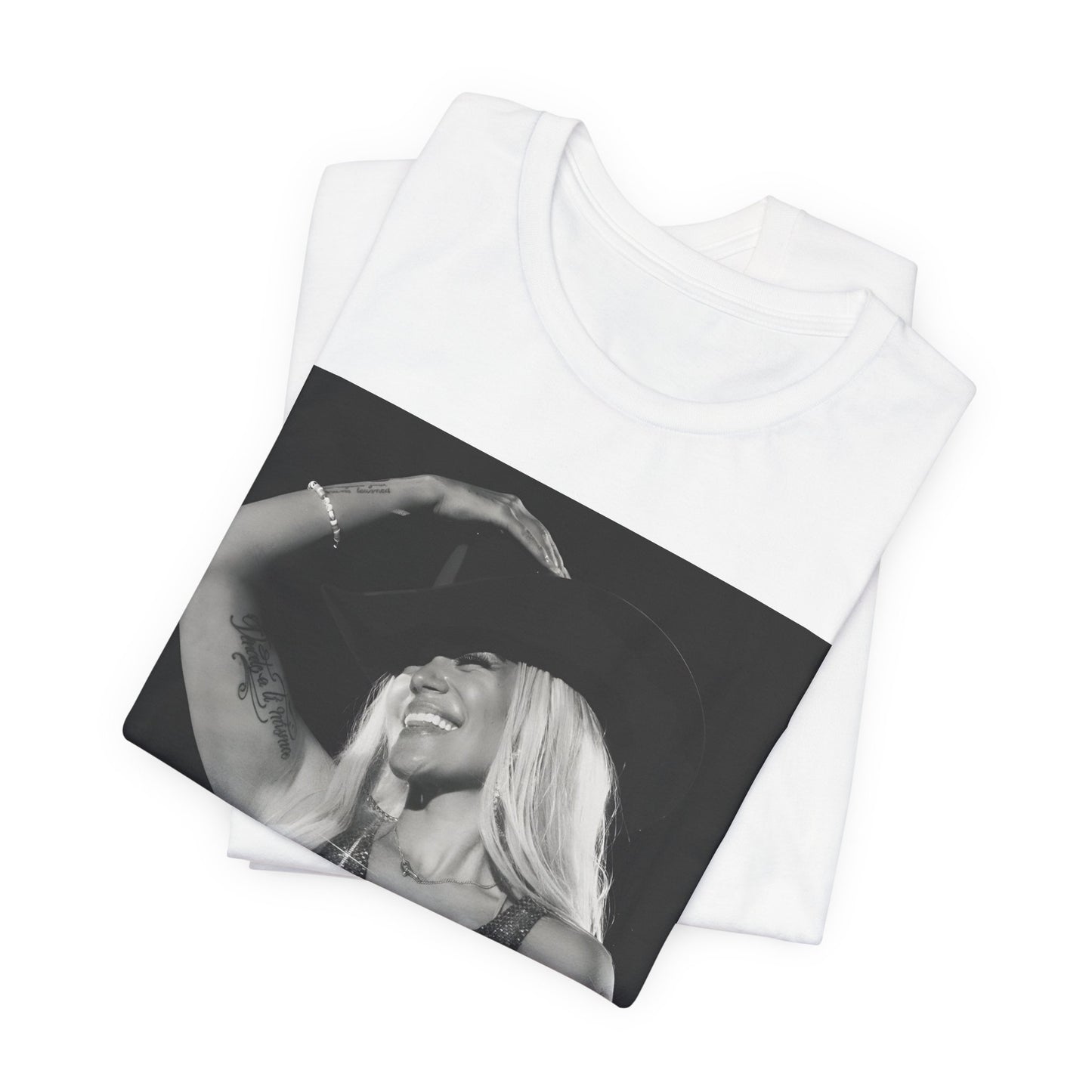 A black graphic t-shirt featuring a black and white graphic or photo of Karol G performing live on stage.